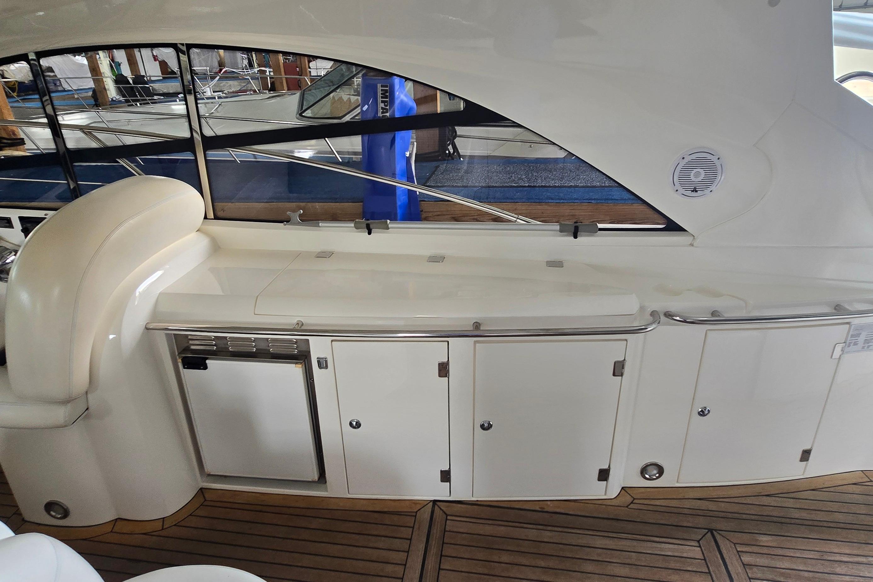 2004 Sunseeker Camargue 50 yacht interior with sleek cabinetry and wooden flooring.