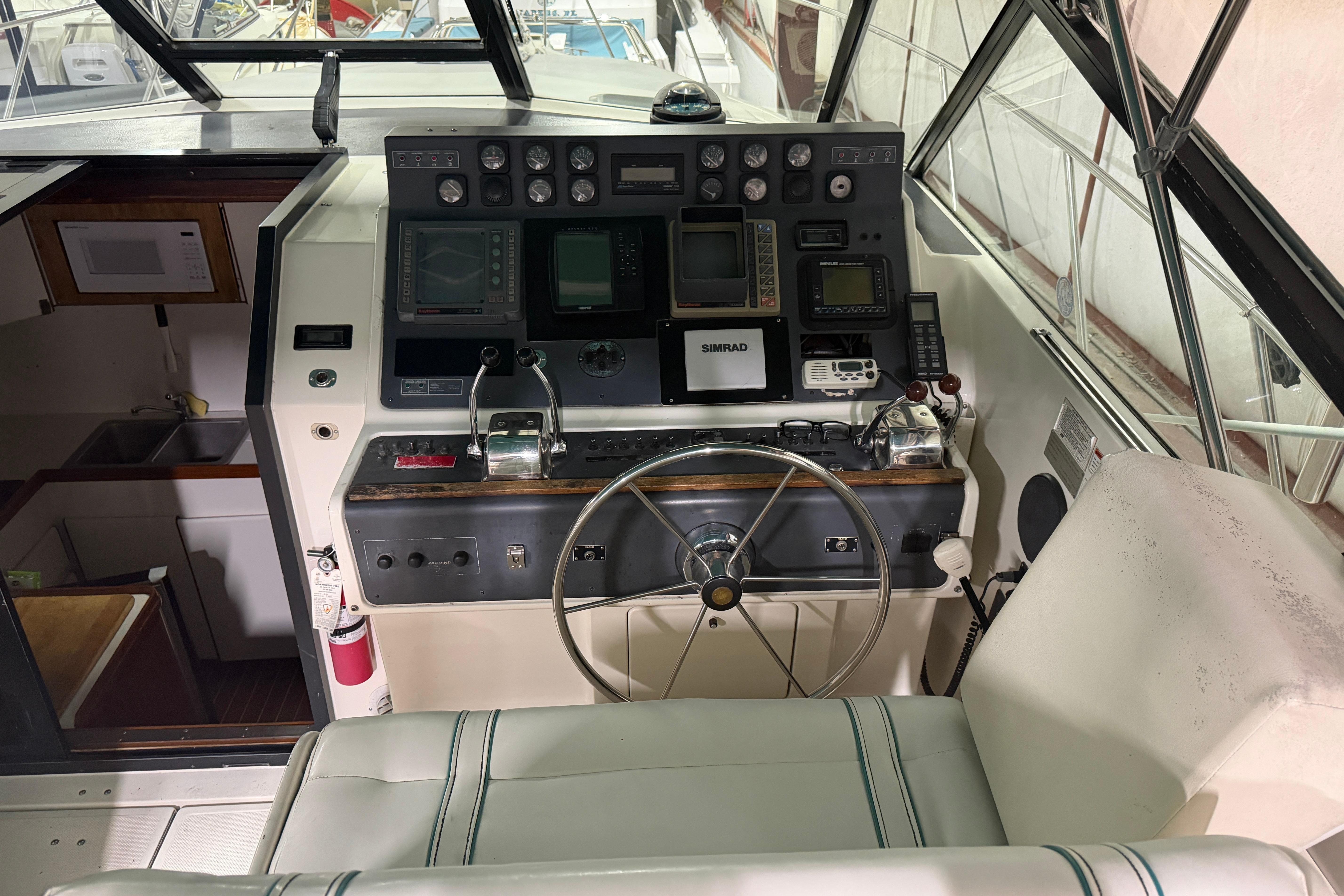 1989 Tiara Yachts 3600 Open helm with navigation equipment and steering wheel.
