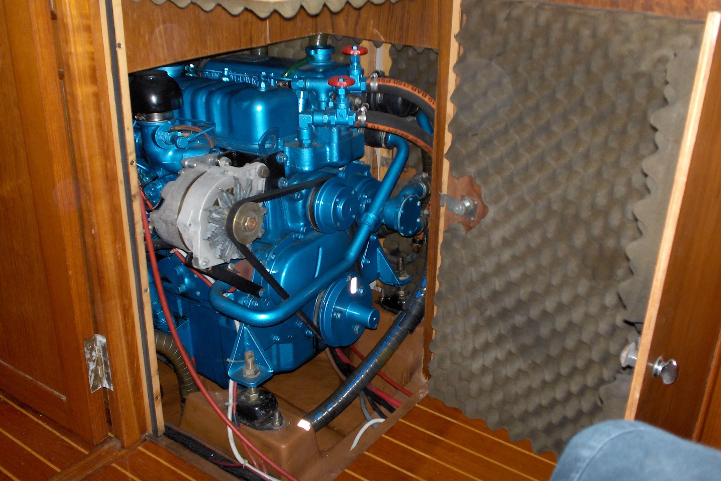 Engine compartment of a 1987 Wauquiez Centurion sailboat, featuring a blue marine engine.