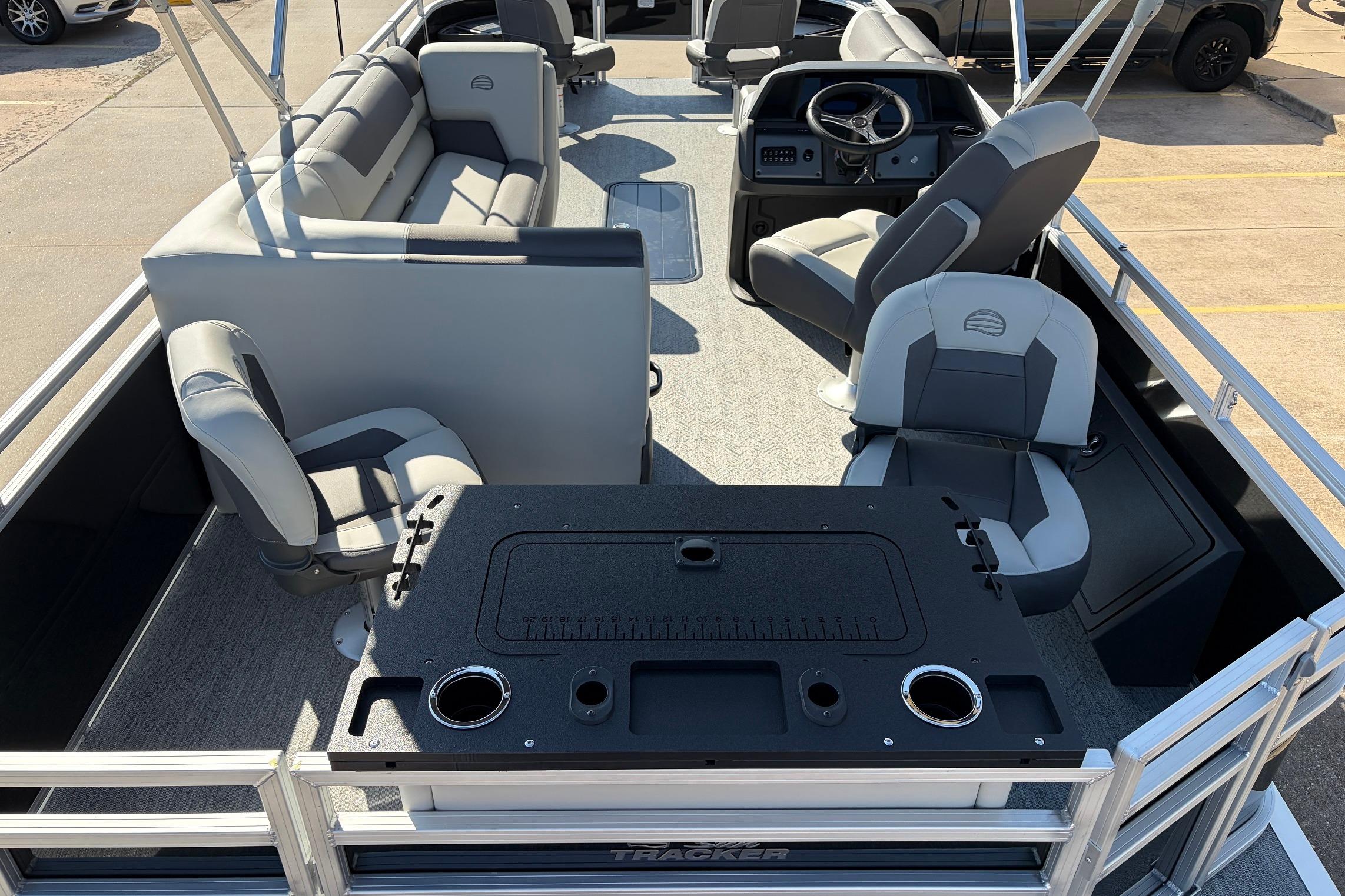 2026 Sun Tracker Fishin' Barge 22 XP3 interior with seating and control console.