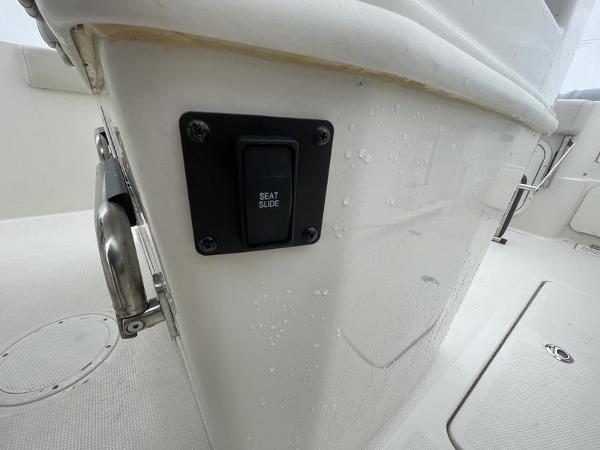 2023 Sailfish 290 CC boat interior with seat slide control button.