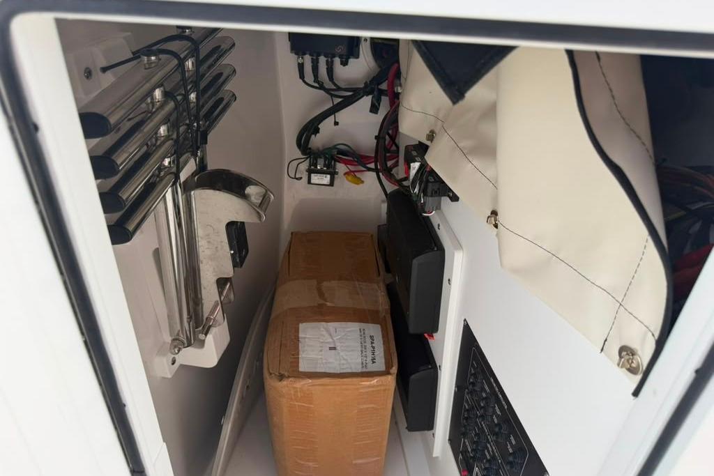 Storage compartment of 2026 Sea Fox 288 Traveler boat with equipment and wiring.
