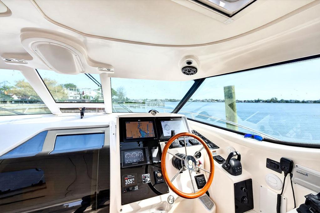 2006 Tiara Yachts 4300 Sovran helm with navigation equipment and scenic water view.