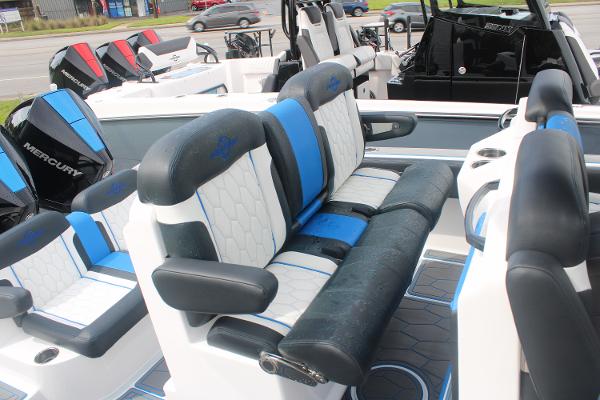 2024 Fountain 34 SC boat interior with blue and white seating, featuring Mercury engines.