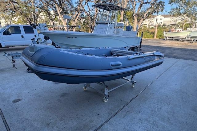 2025 Highfield Classic 340 inflatable boat on a trailer in a marina setting.