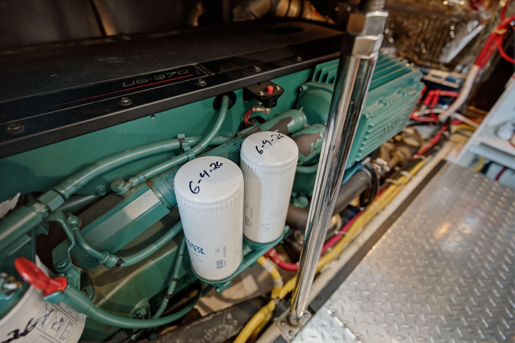 Engine room of 2005 Carver 39 Motor Yacht with visible filters and wiring.
