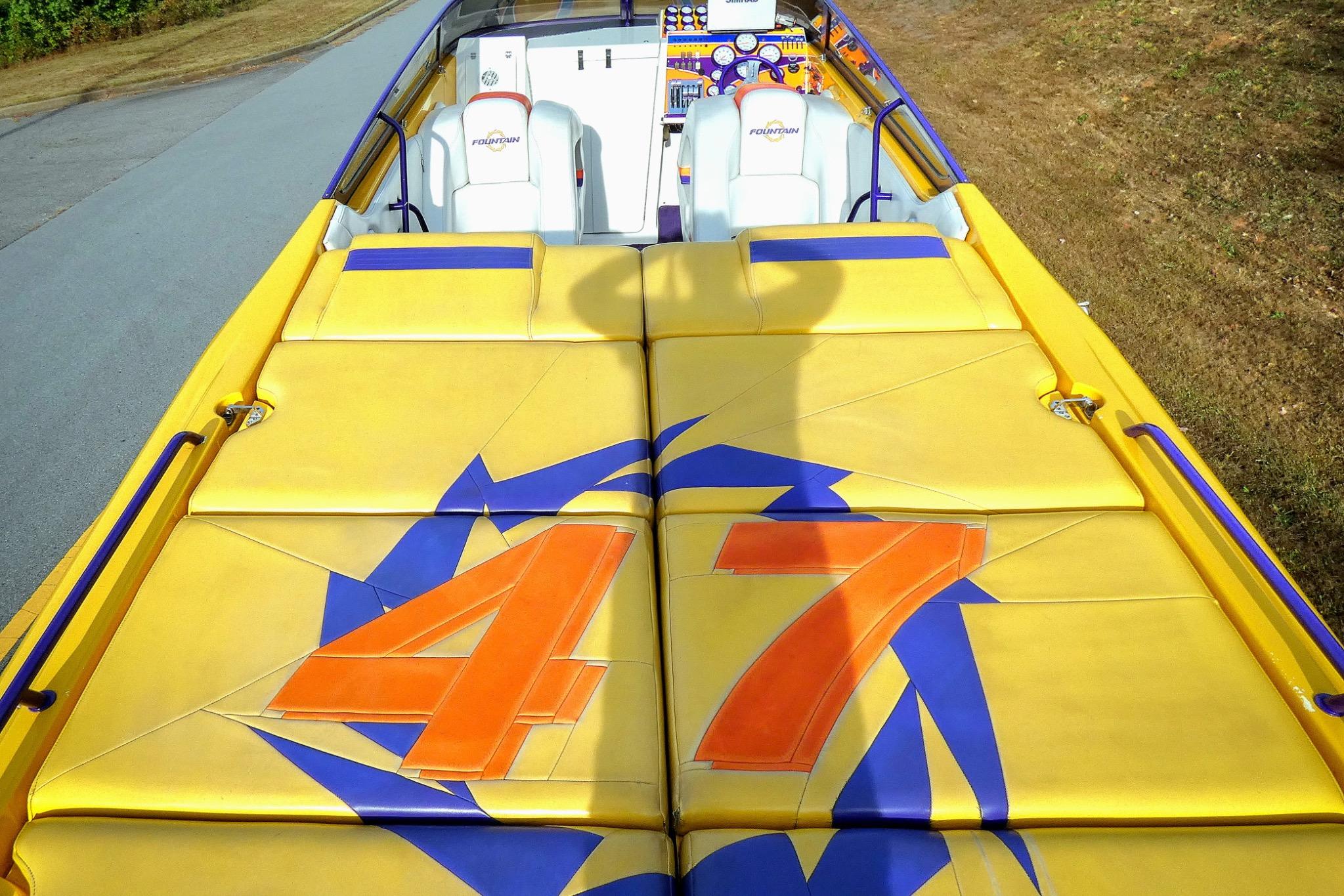 2006 Fountain 47 Lightning boat with vibrant yellow and blue design, featuring bold "47" graphics.