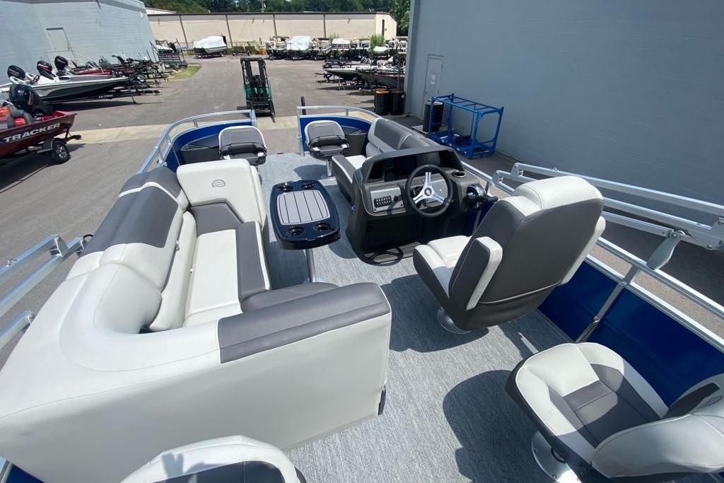 2026 Sun Tracker Fishin' Barge 20 DLX interior with seating and steering console.