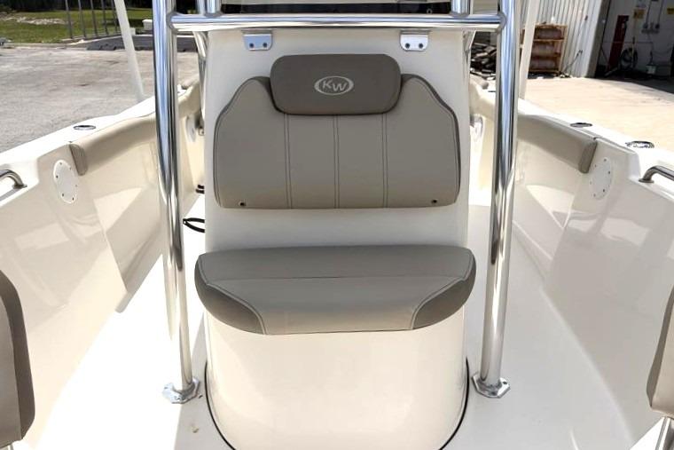 2023 Key West 203 FS boat interior with beige seating and stainless steel accents.