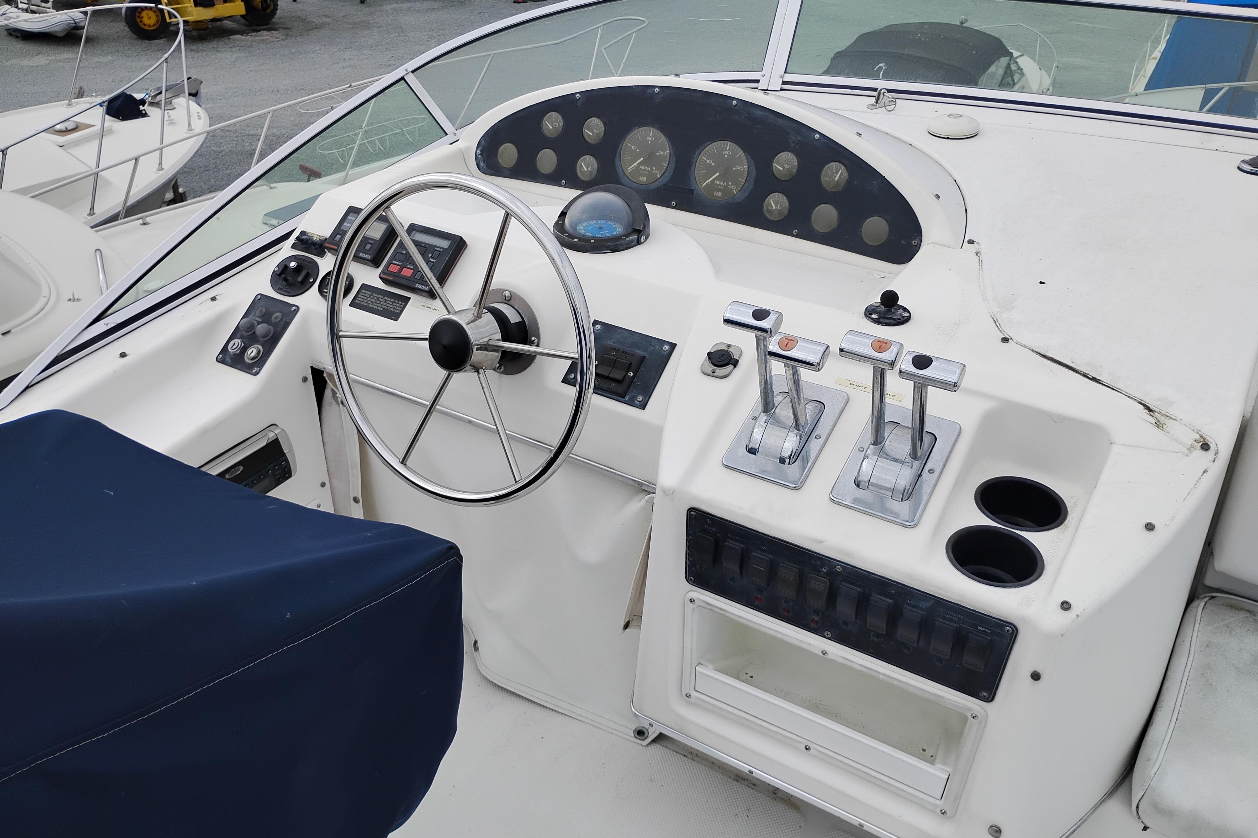 1995 Bayliner 3988 Motoryacht helm with steering wheel, controls, and gauges.