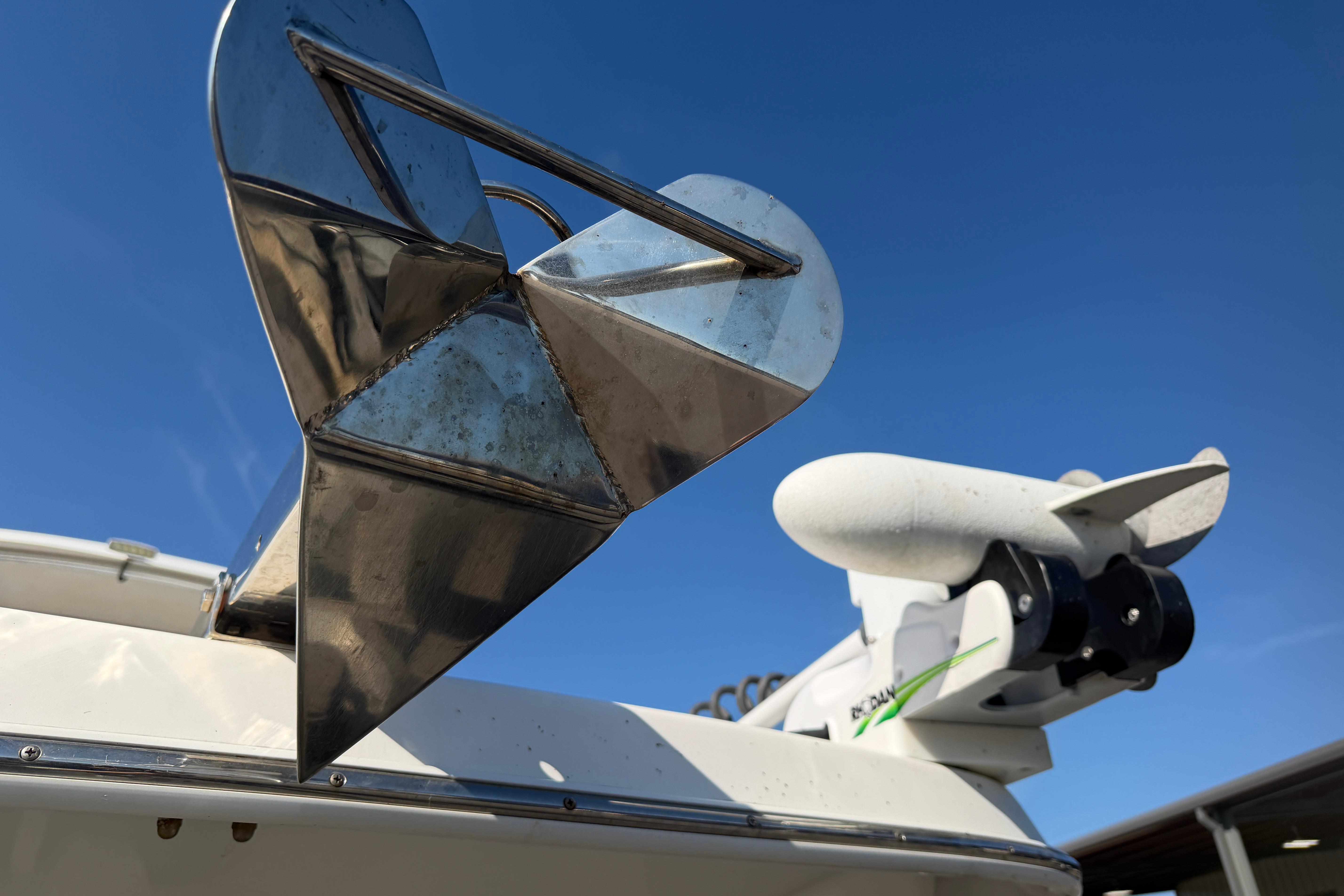 2018 Twin Vee 260 CC SE boat anchor and motor against clear blue sky.