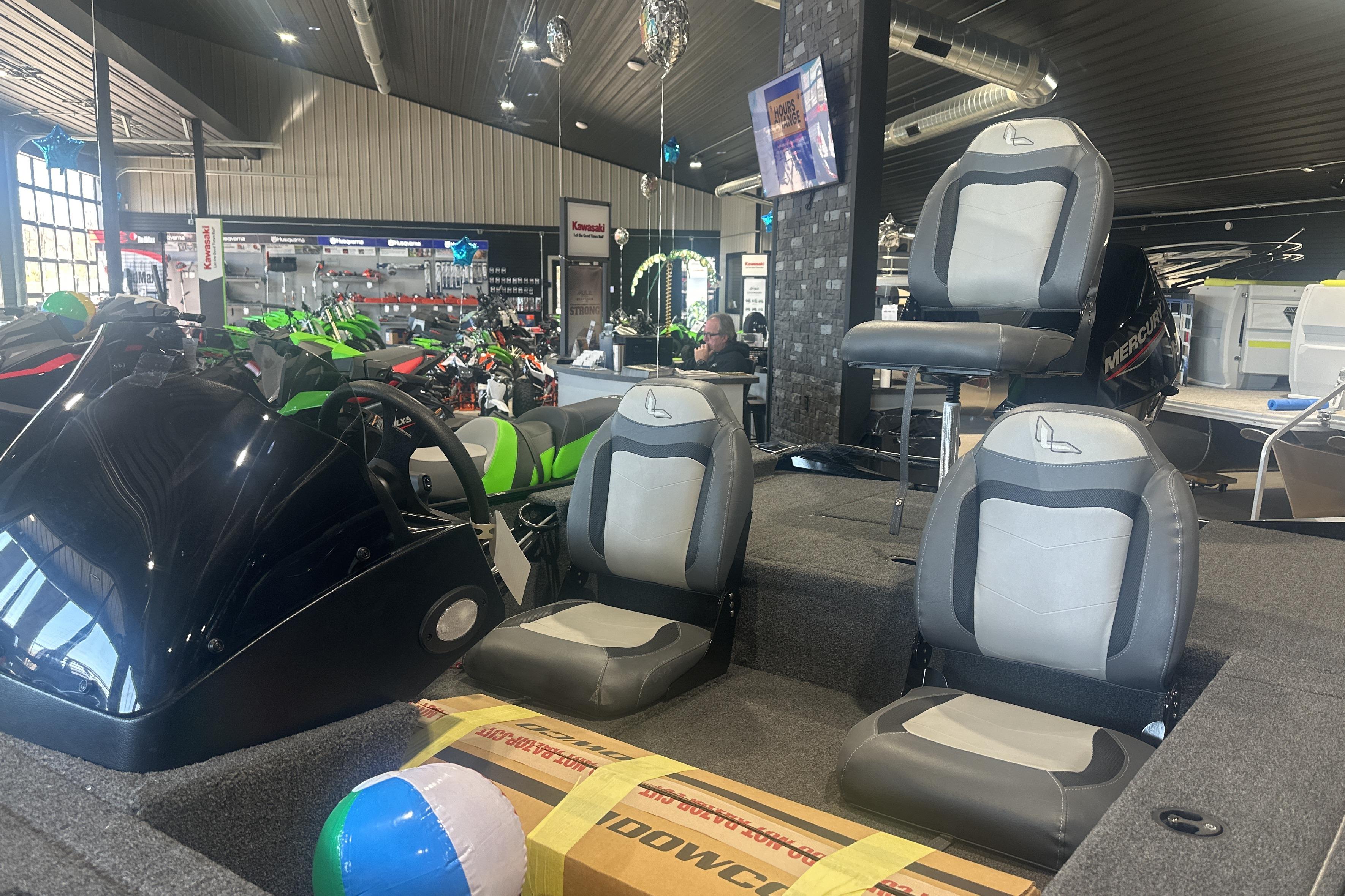 2025 Lowe Skorpion 16 boat interior with seating, displayed in a showroom.
