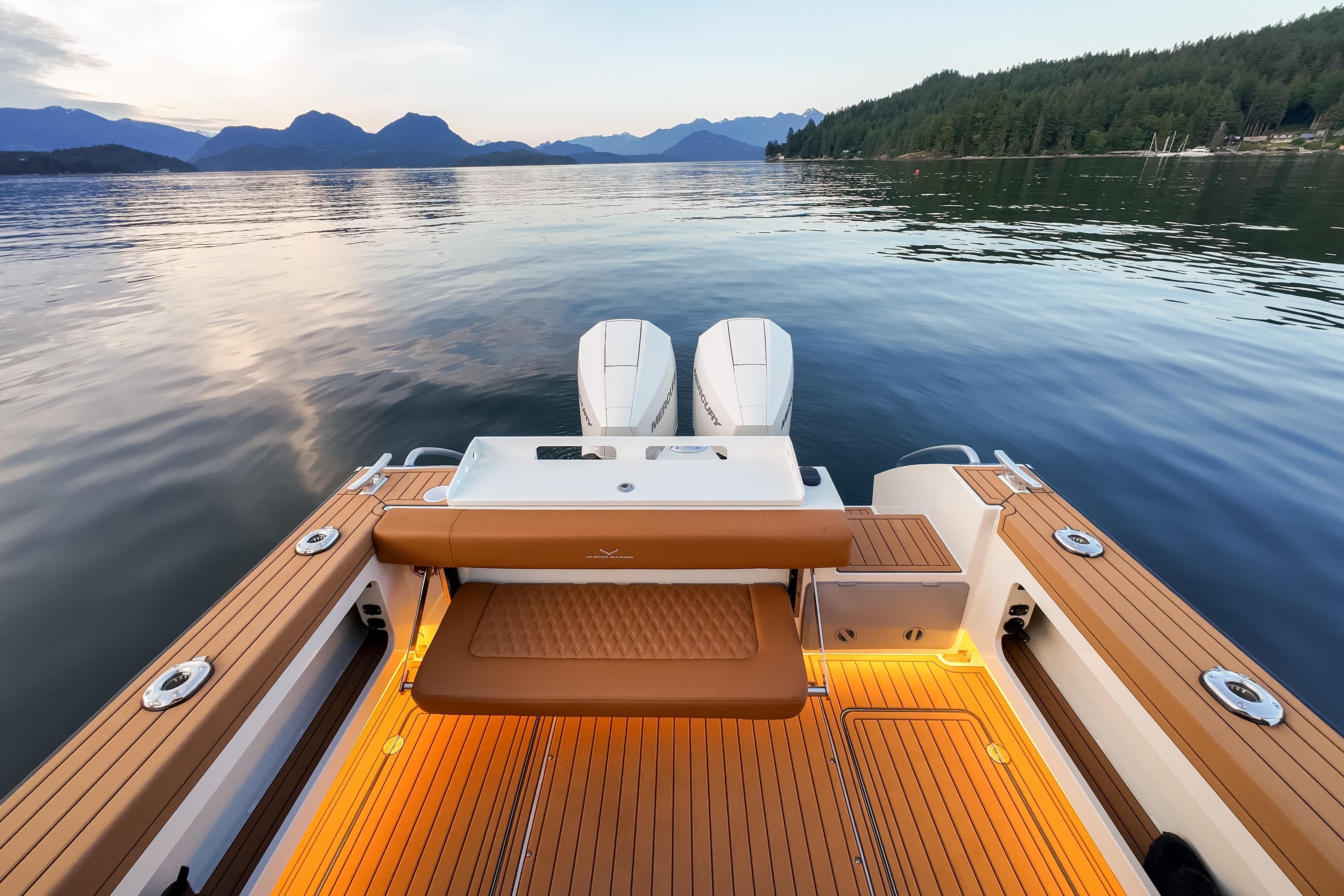 Jasper Marine Defender 22 boat, 2026 model, on serene lake with scenic mountain backdrop.