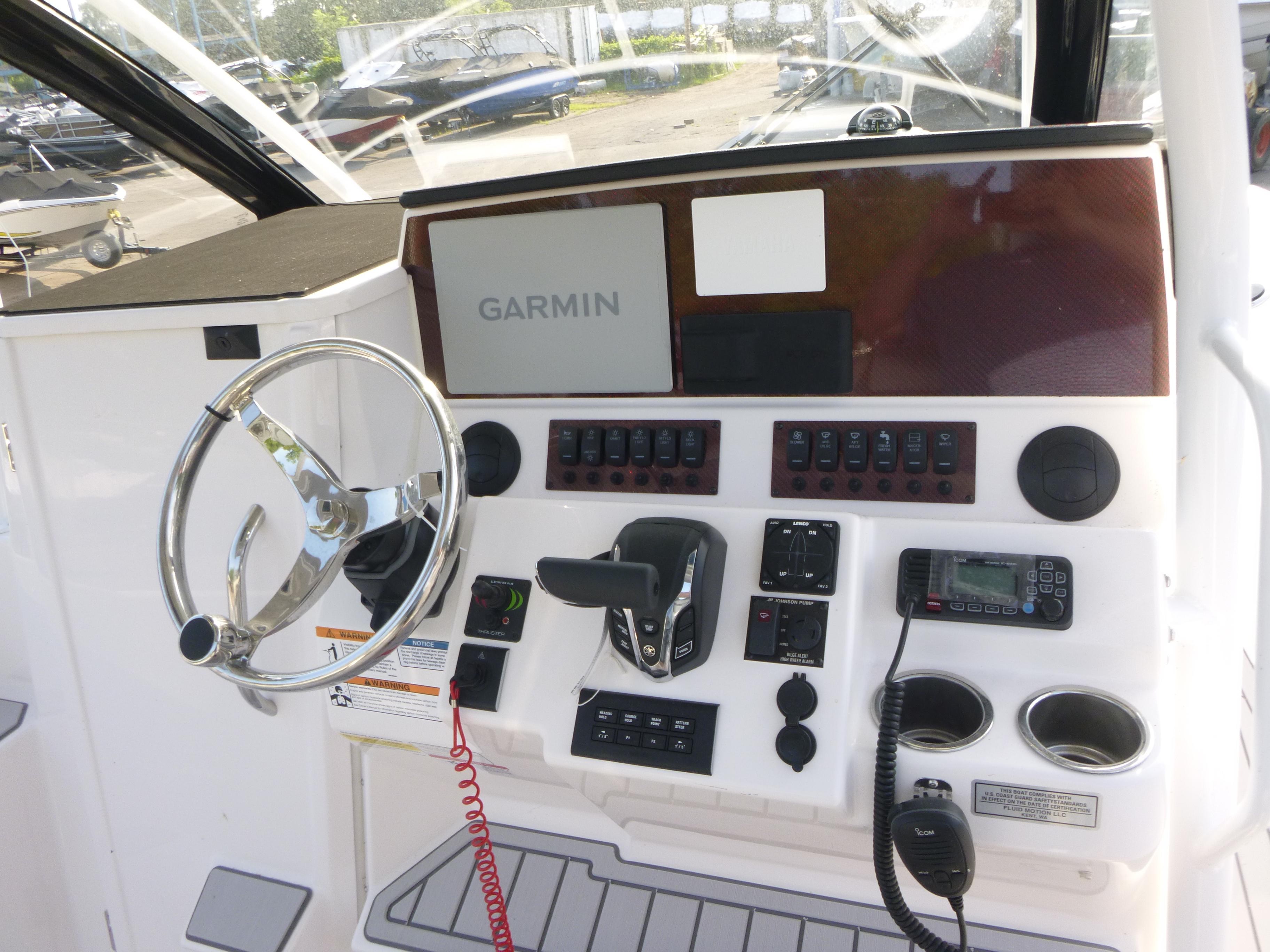 2025 Solara S-250 CW boat dashboard with Garmin navigation, steering wheel, and control panel.