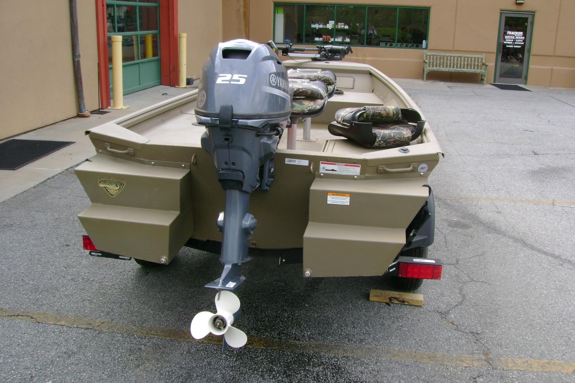 2023 G3 1652 DK boat with Yamaha 25 outboard motor, parked outdoors.