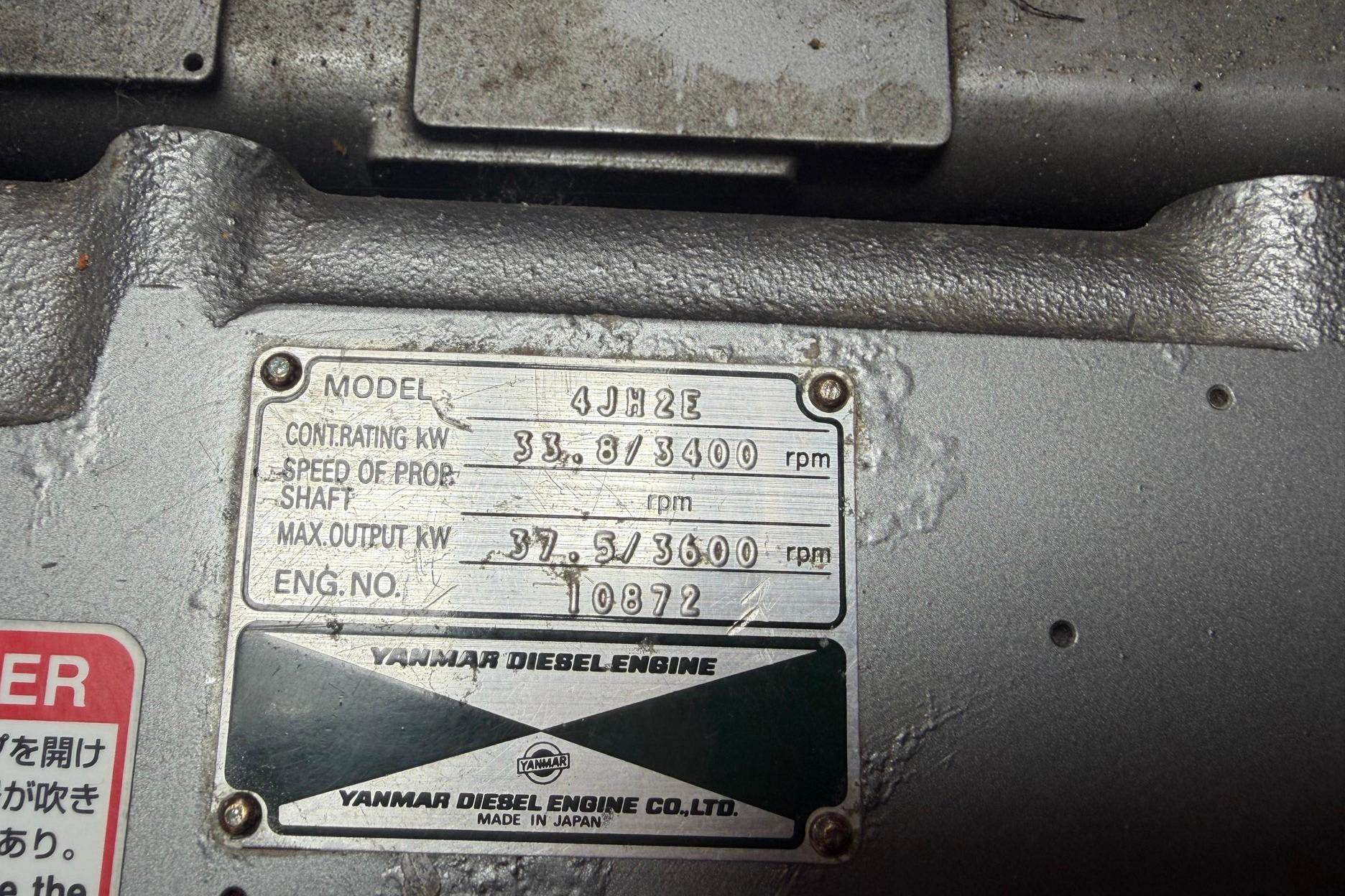 Engine plate of Yanmar Diesel, model 4JH2E, showing specifications and serial number.