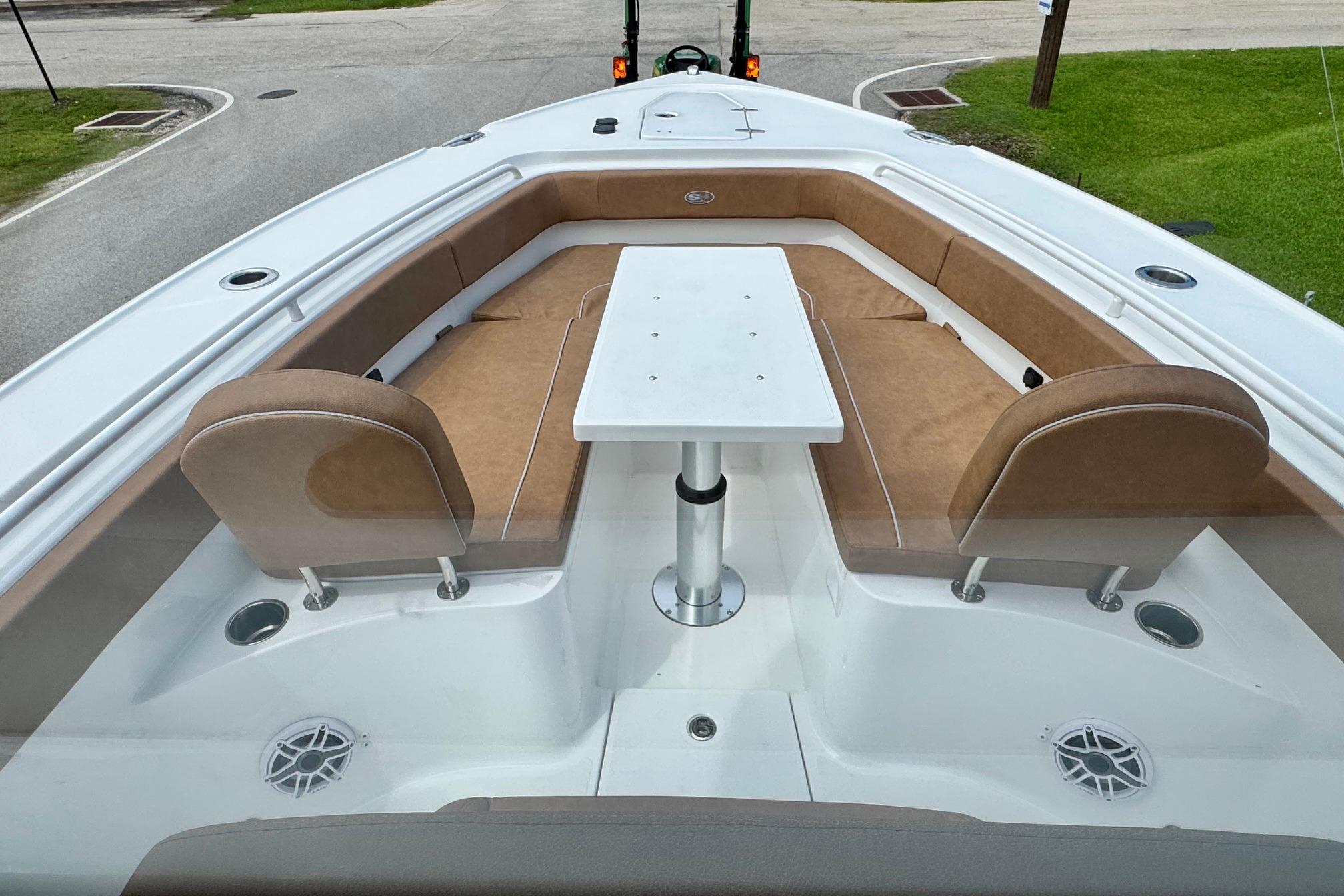 2026 Sea Hunt Ultra 275 SE boat interior with tan seating and central table.