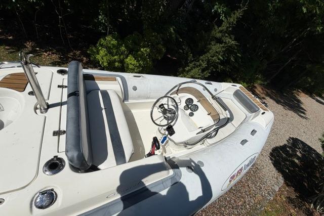 2016 Walker Bay Generation 450 DLX boat interior with steering wheel and seating.