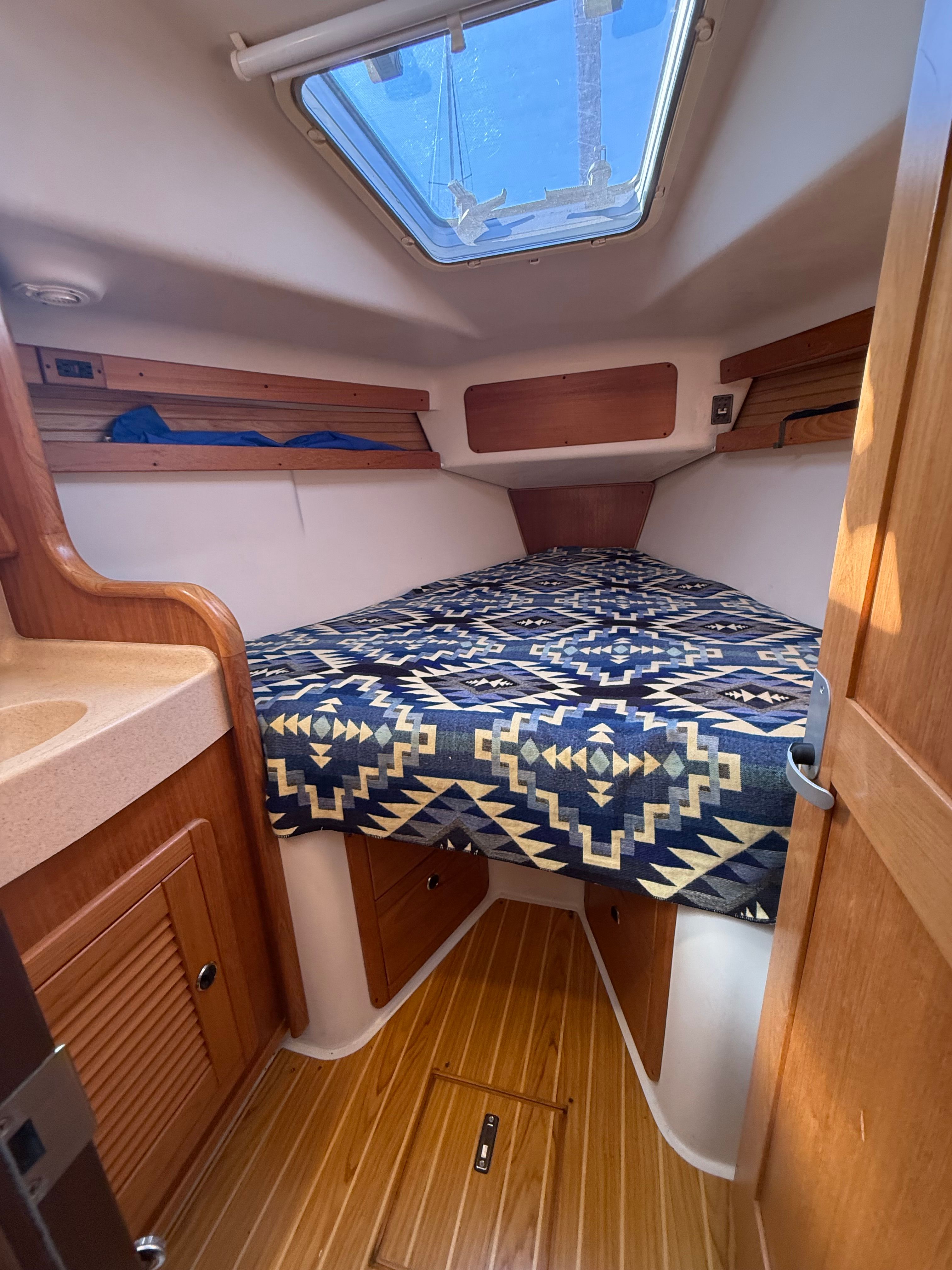 Interior of a 2003 Catalina 380 yacht with cozy bed.