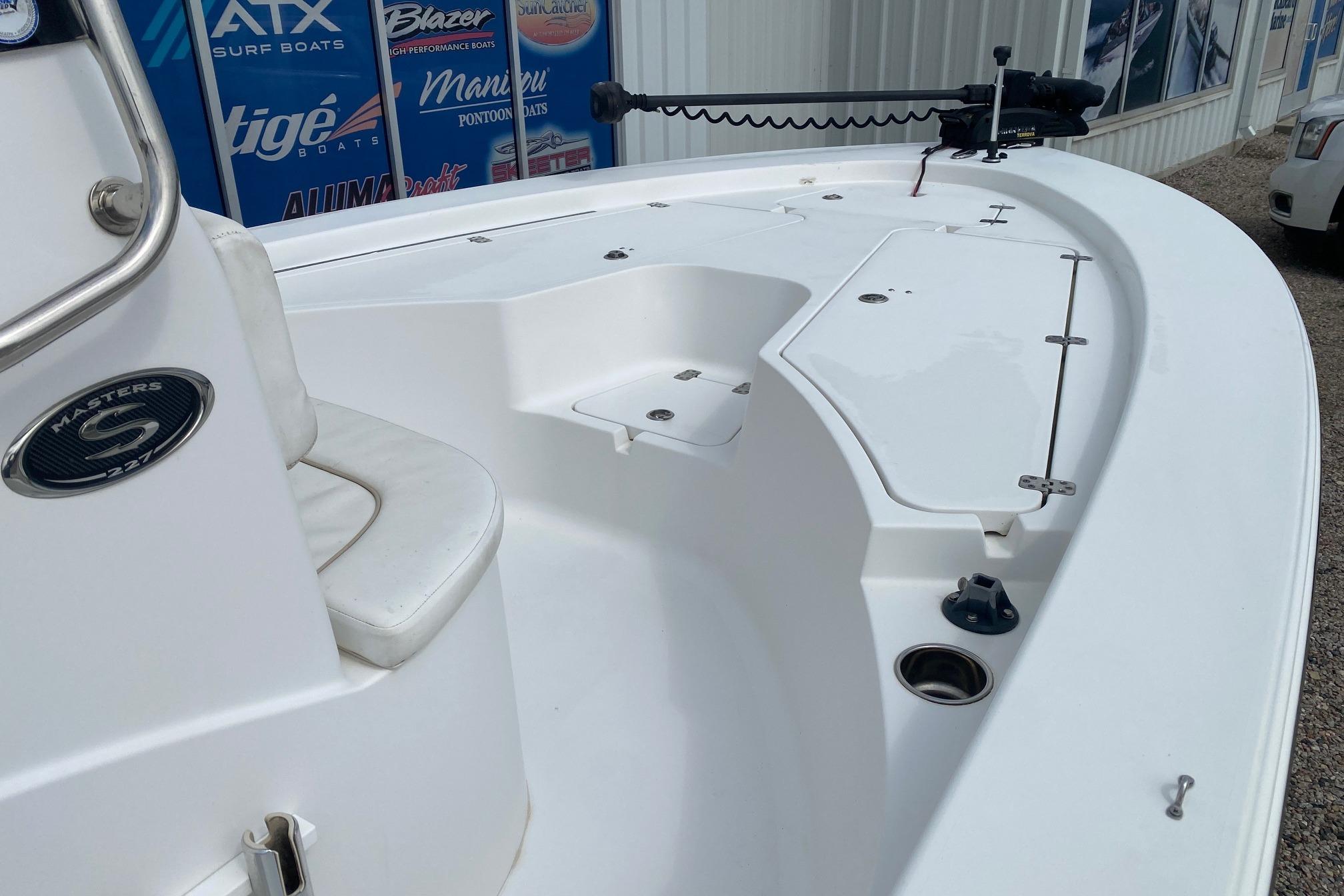 2013 Sportsman Masters 227 Bay Boat deck view, showcasing seating and storage compartments.
