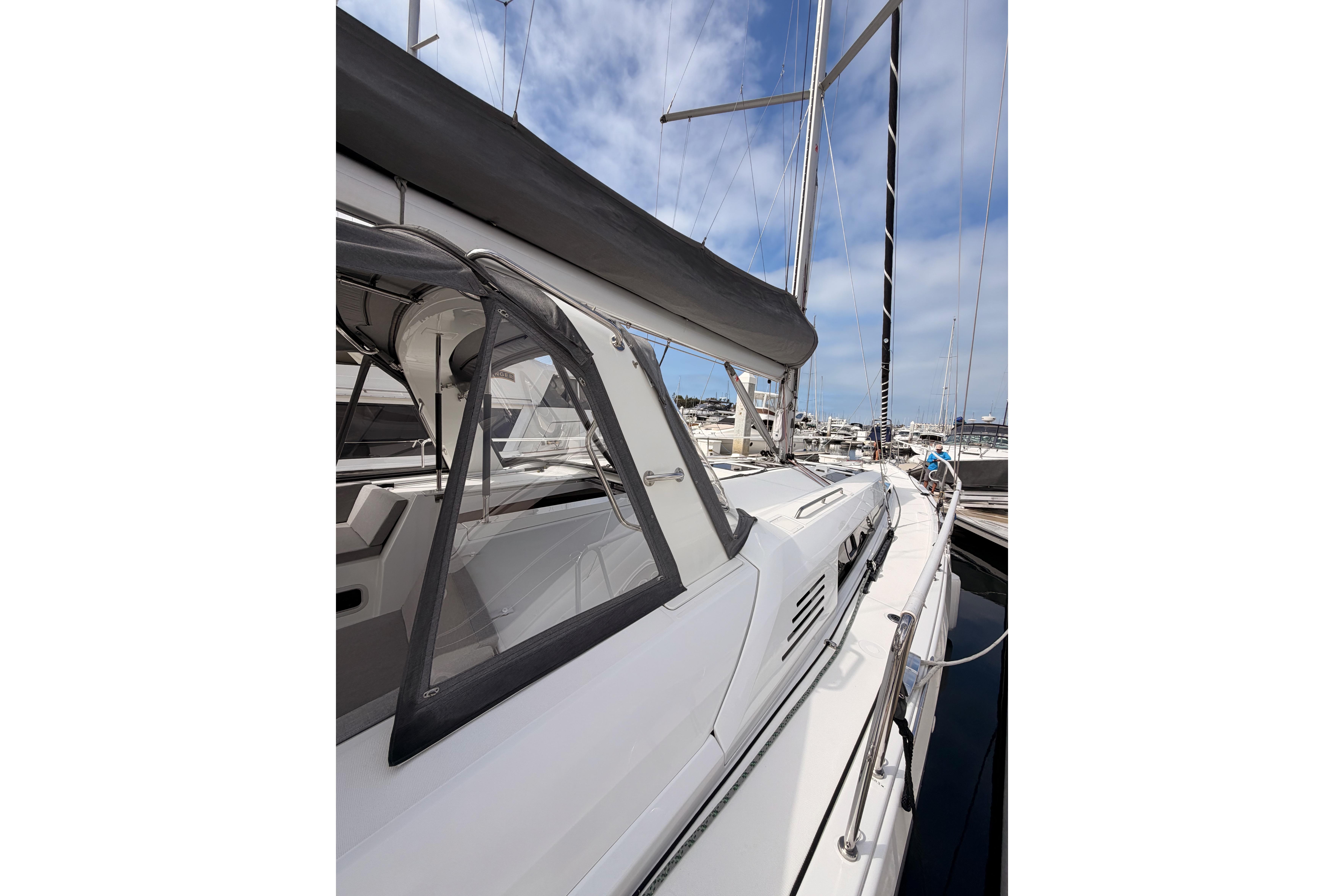 2020 Beneteau Oceanis 46.1 sailboat docked at marina under blue sky.