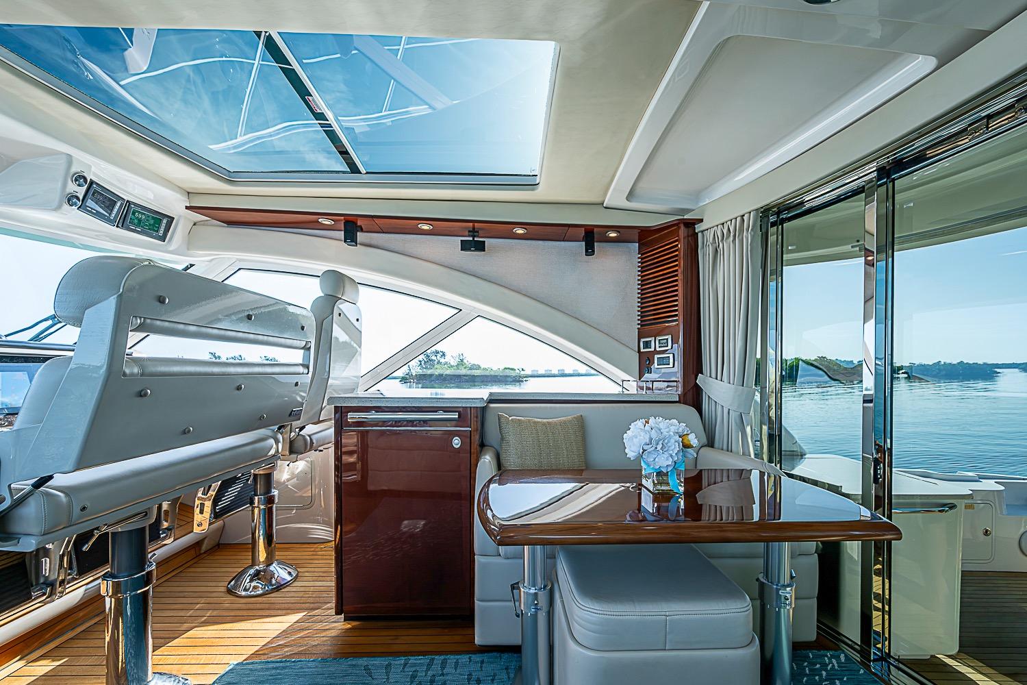 Luxurious interior of 2008 Sea Ray 60 Sundancer yacht with panoramic windows and elegant seating.