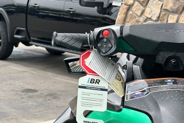 Close-up of a Sea-Doo PWC GTR 230 with controls and tags.