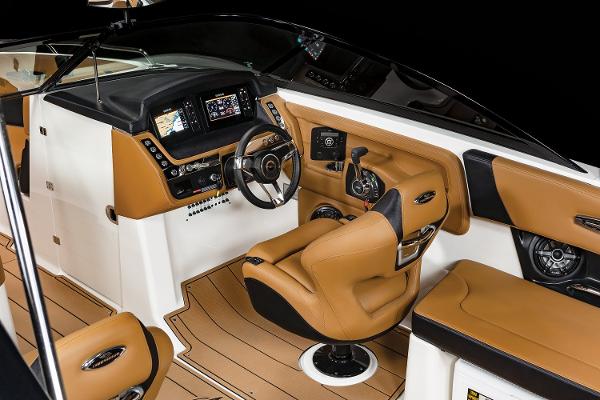 2024 Chaparral 28 Surf boat interior with tan leather seats and modern dashboard.