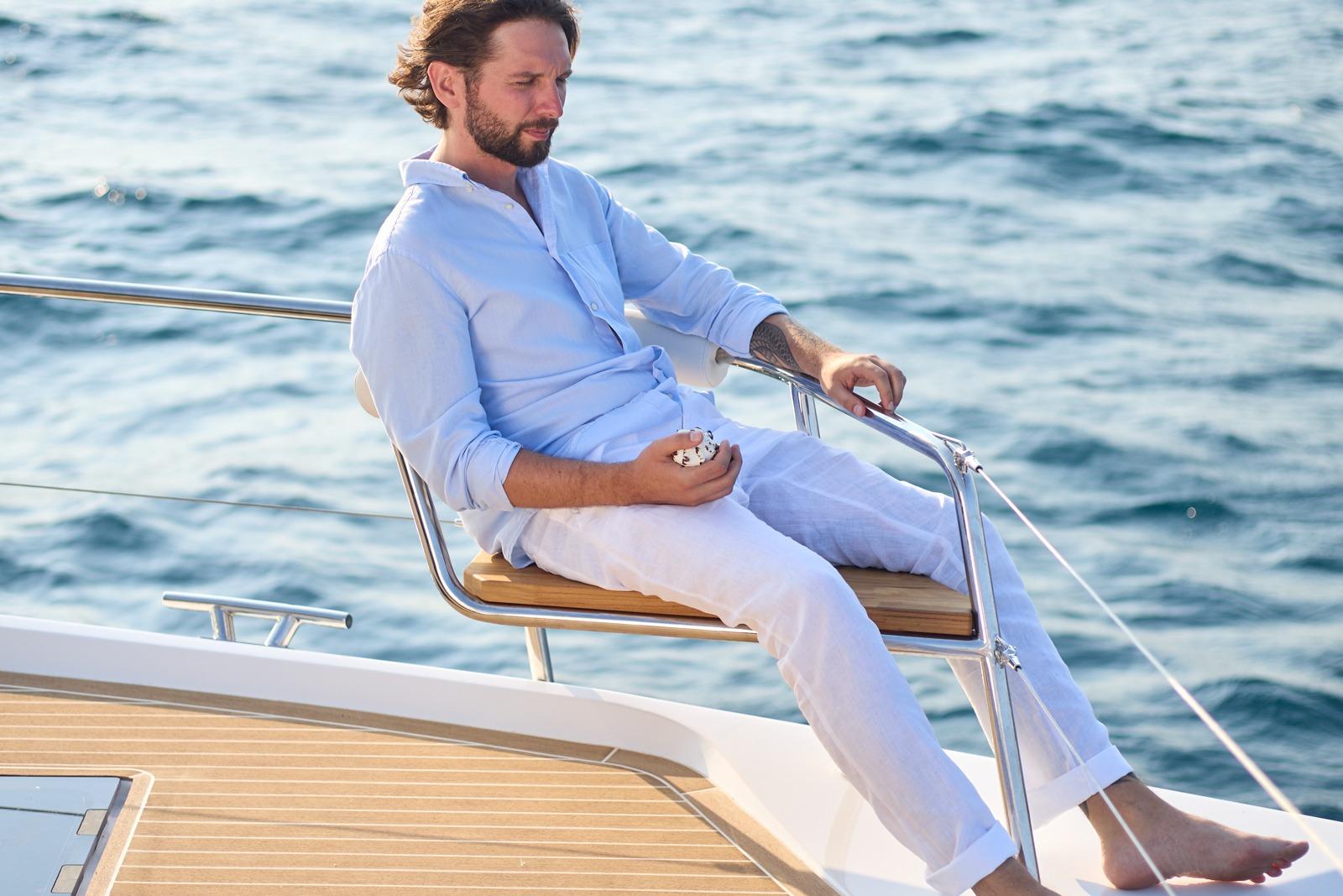 Man relaxing on 2025 Omaya 50 Power Catamaran, enjoying the ocean view.