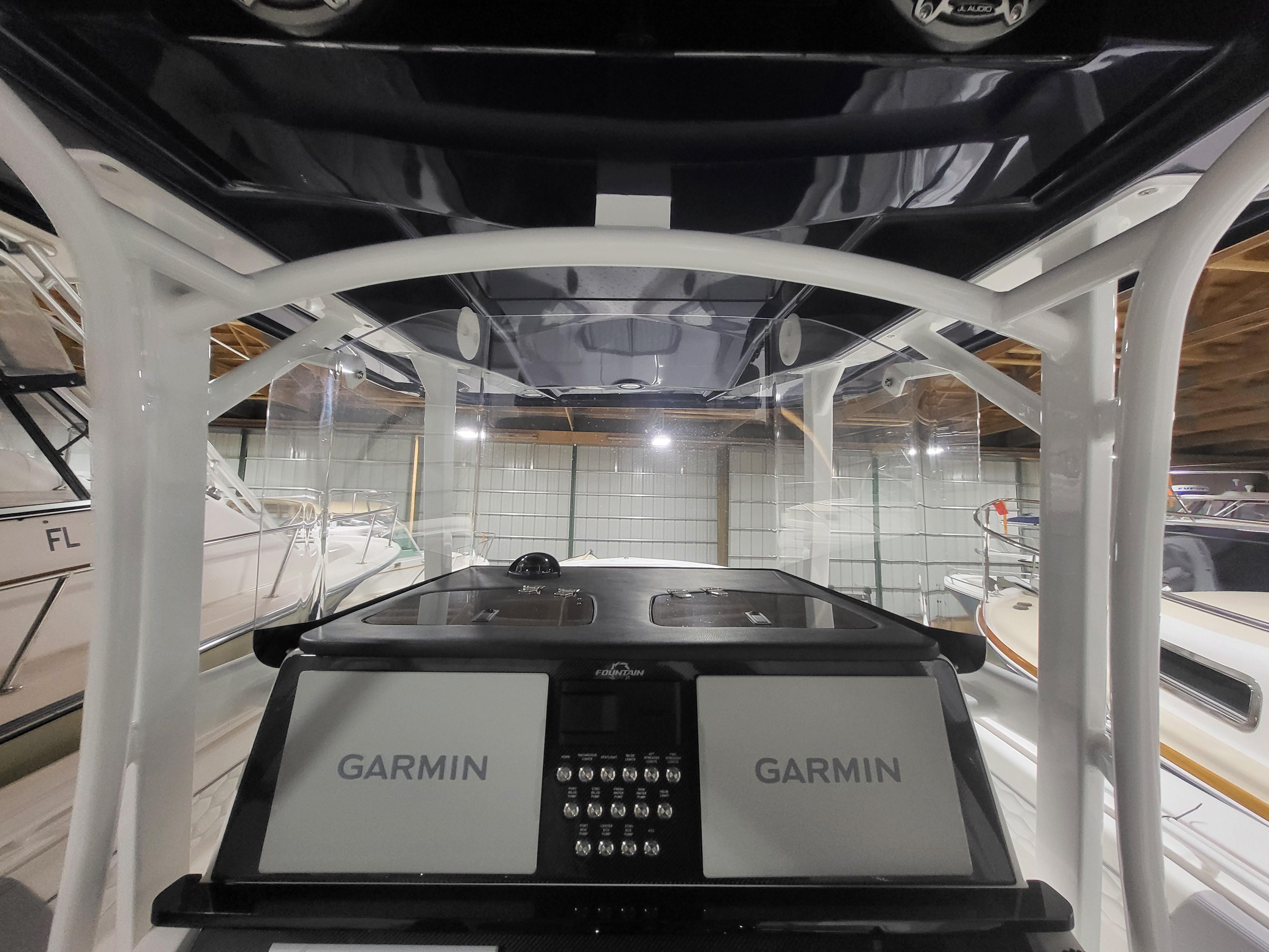 2022 Fountain 38 SC boat cockpit with dual Garmin displays in a showroom.