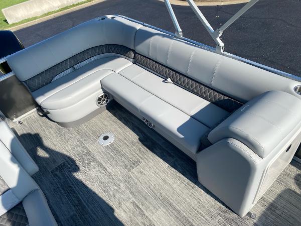 2024 Ranger Reata 223C boat interior with gray seating and carpeted floor.