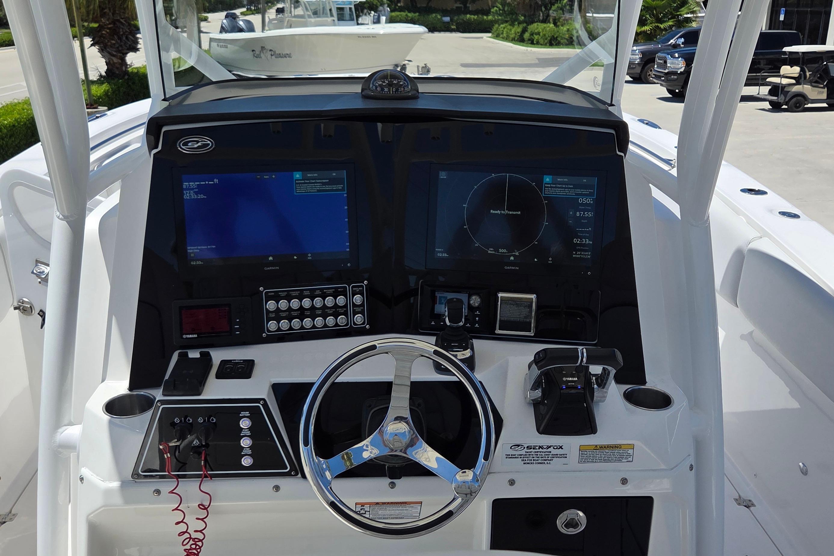 2021 Sea Fox 328 Commander boat dashboard with dual screens and steering wheel.