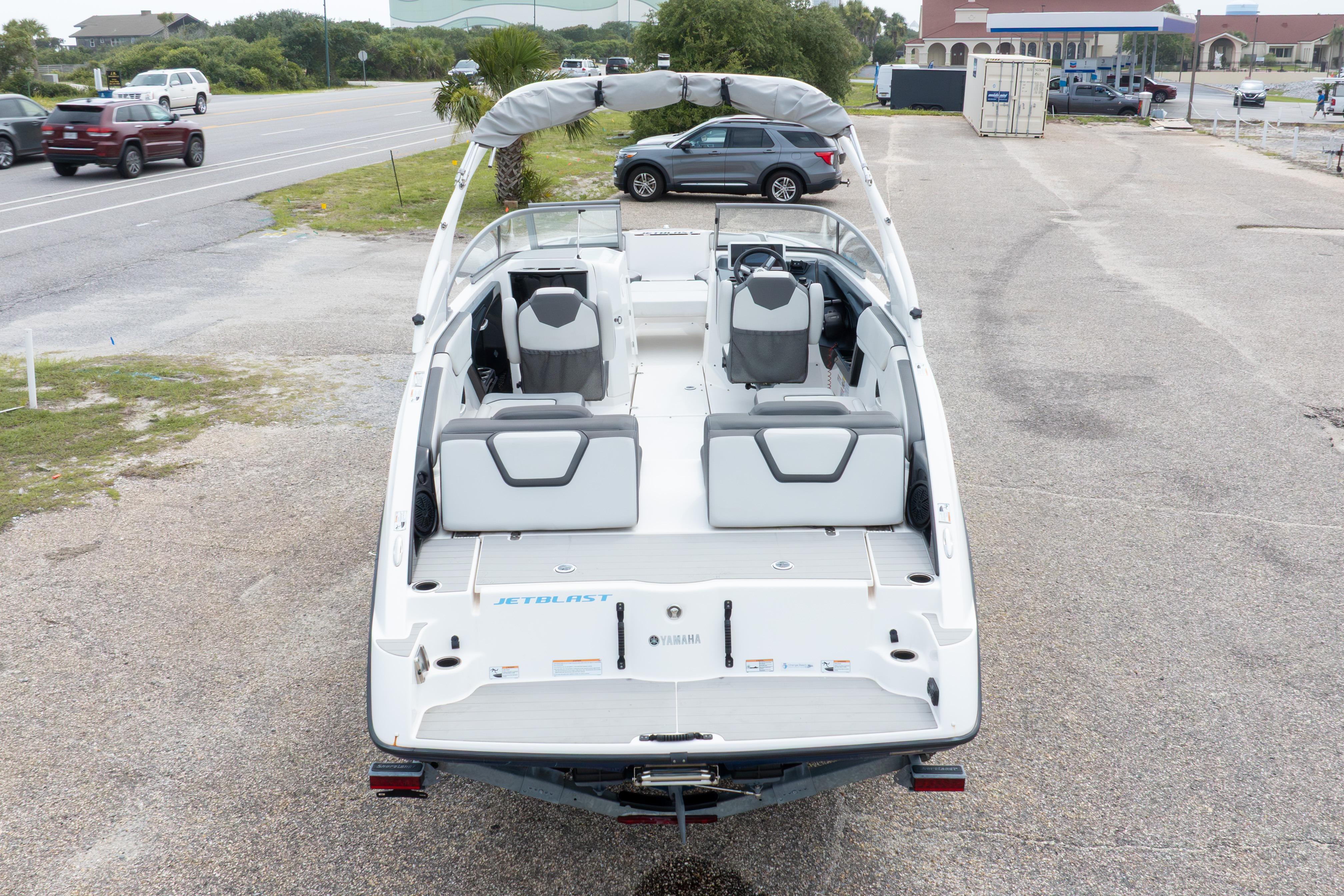 2021 Yamaha Boats AR250 on trailer, rear view, parked in lot.