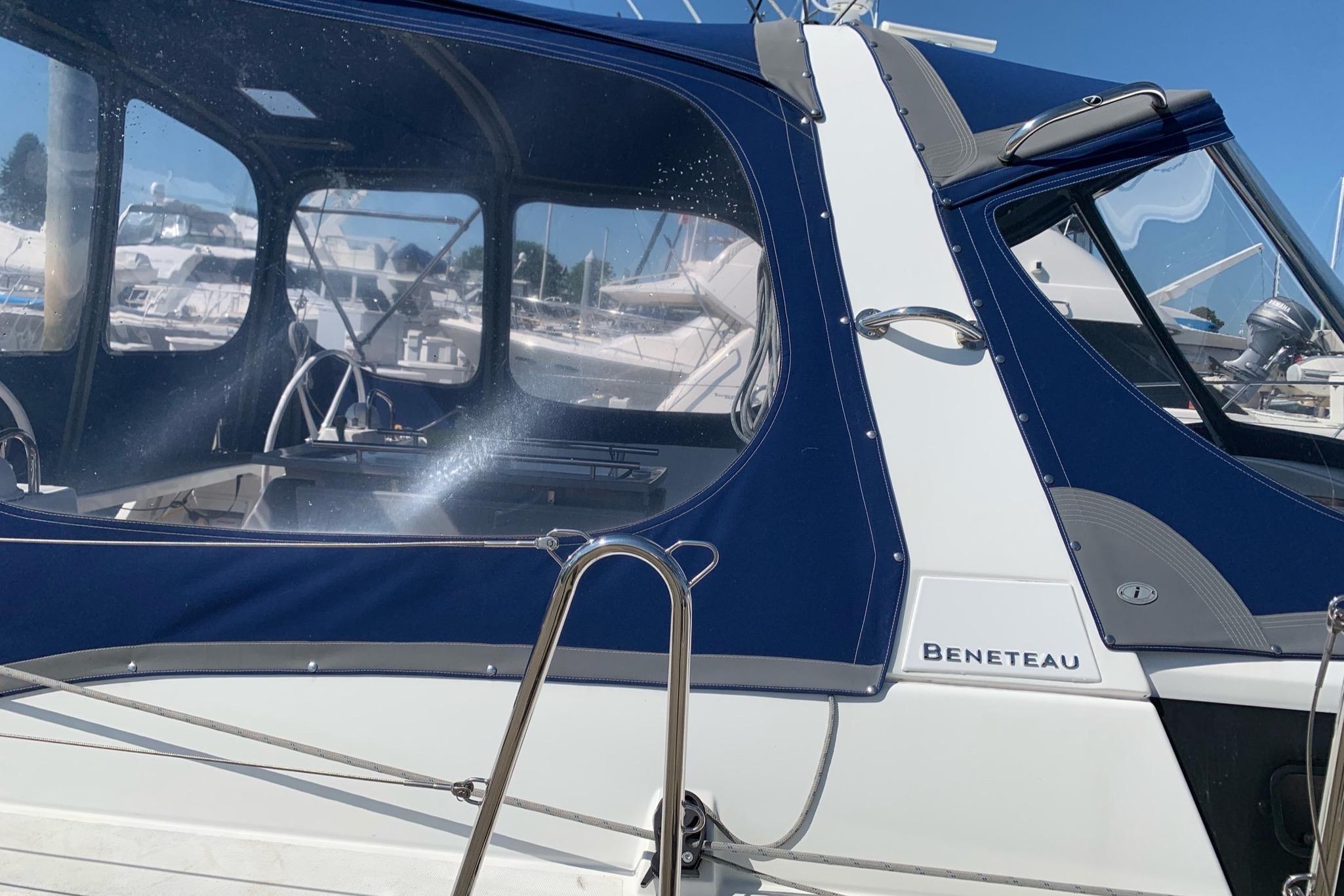 2018 Beneteau Oceanis 45 sailboat with blue canopy, docked in marina.