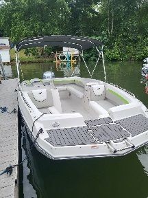 The image shows a 2023 Starcraft SVX 191 OB boat docked by a pier.