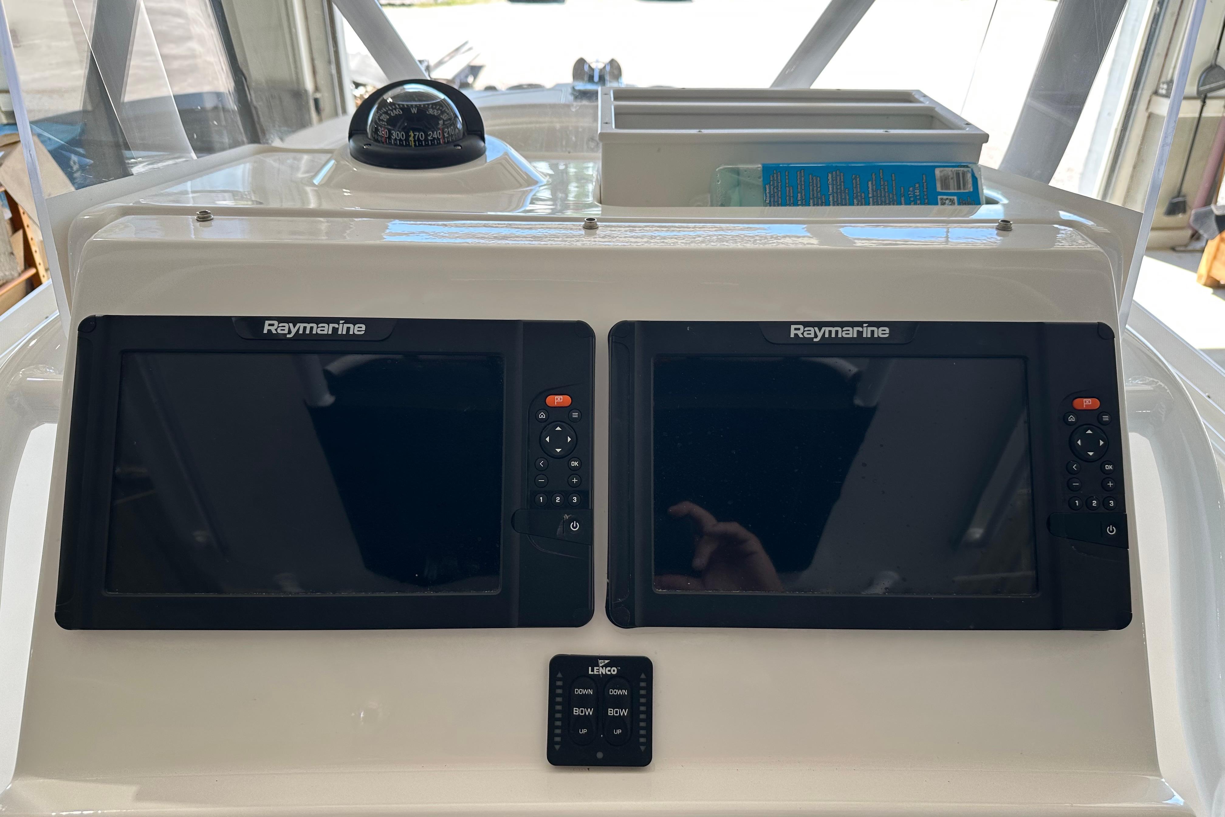 Dashboard of 2015 Edgewater 245CC with dual Raymarine displays and compass.