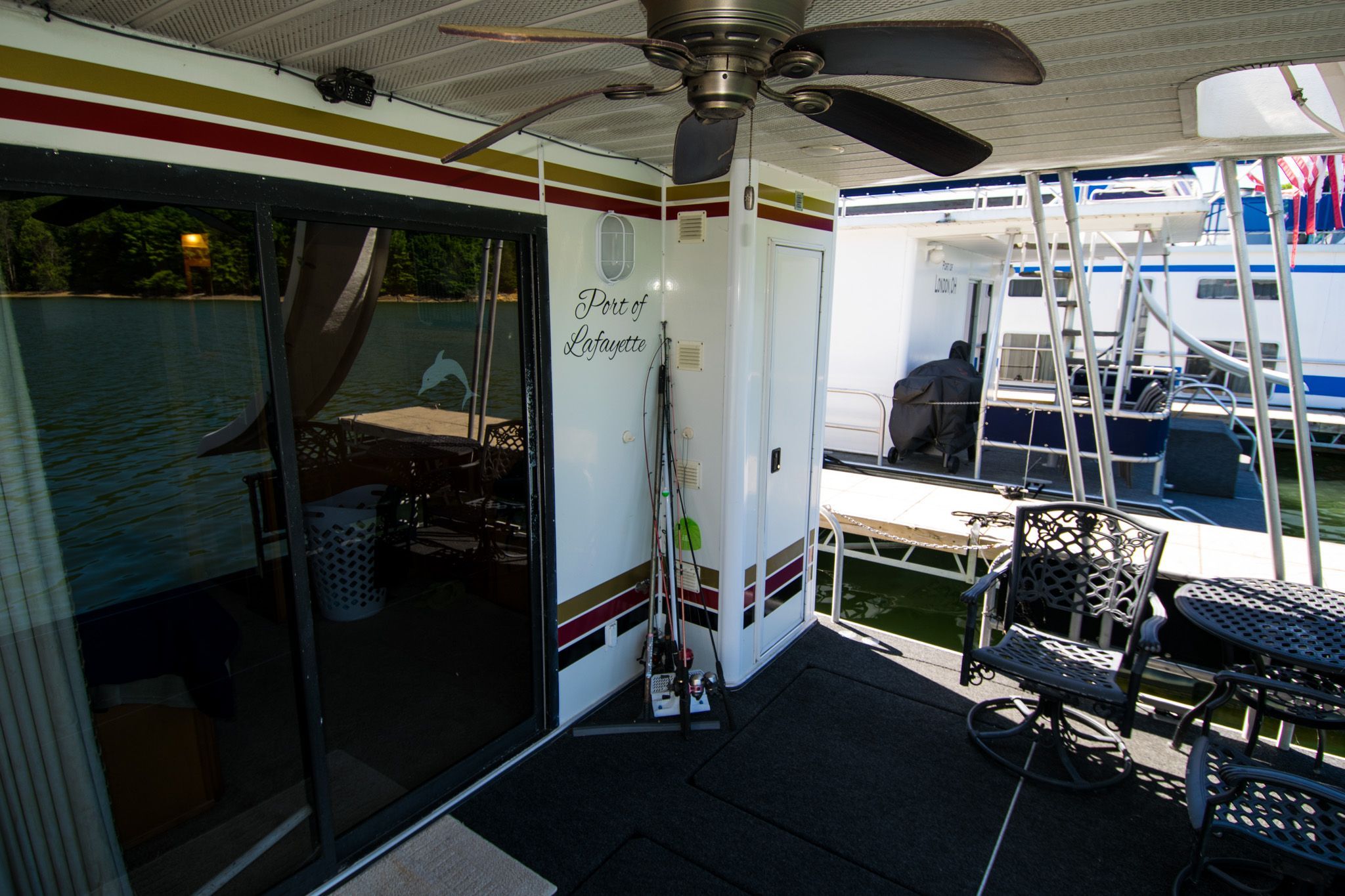 2003 Lakeview 16x70 houseboat docked with patio area.
