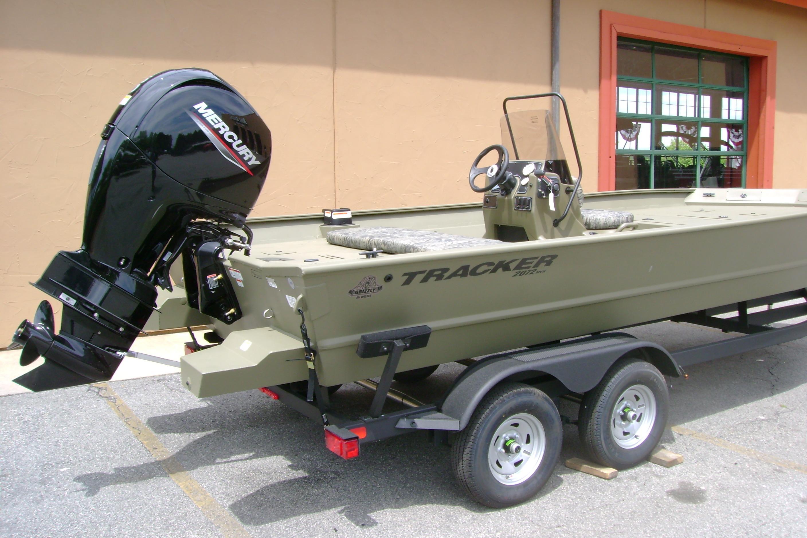 2026 Tracker Grizzly 2072 CC boat on trailer with Mercury outboard motor.