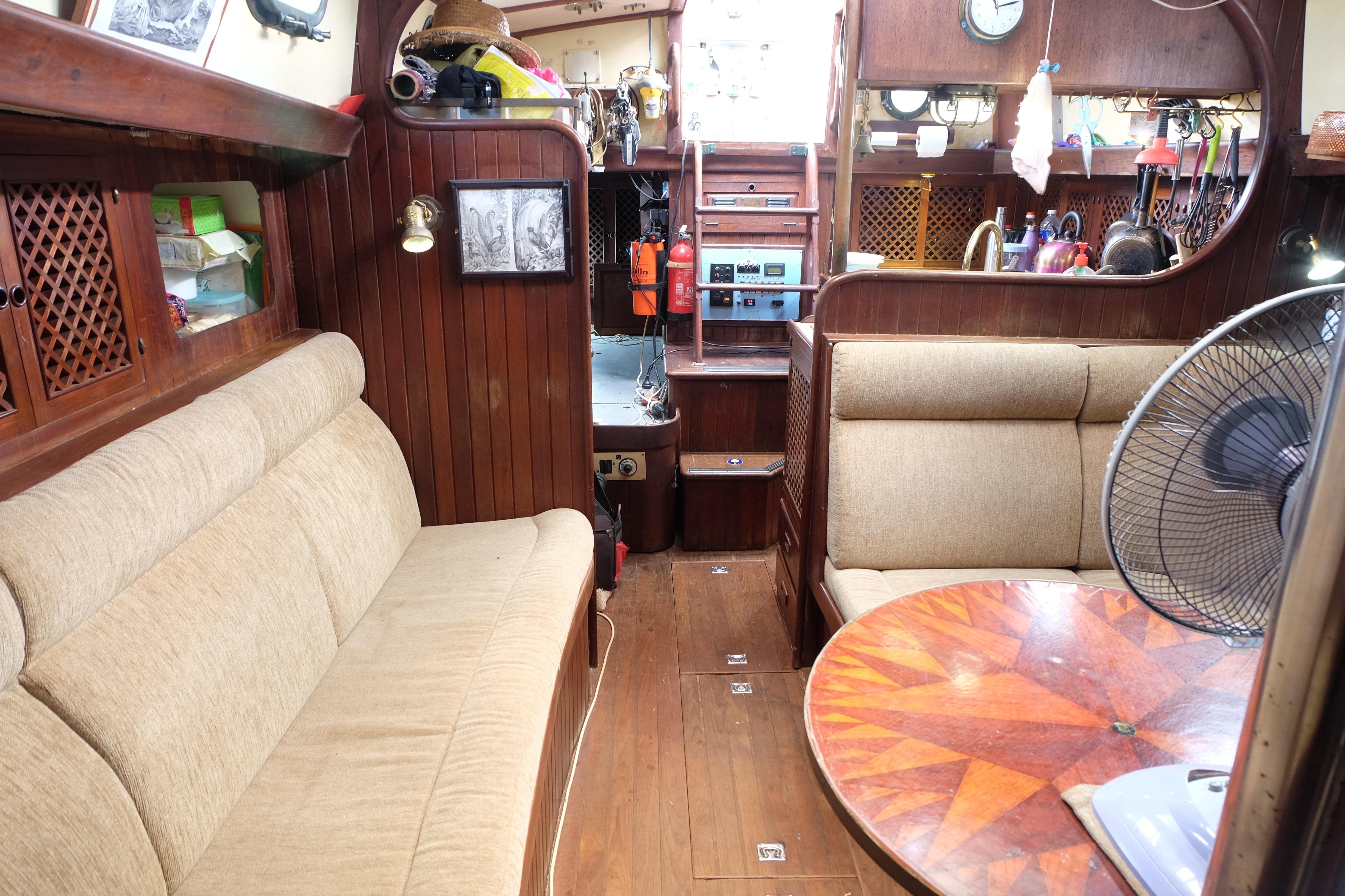 Cozy interior of a 1979 Westwind 35 sailboat with wooden furnishings and seating.