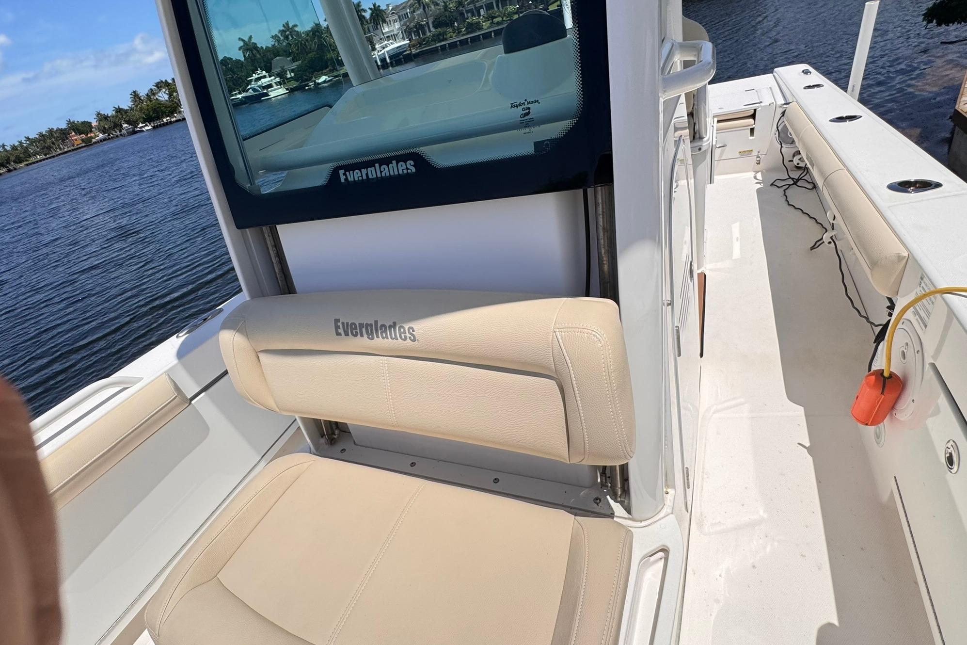 2018 Everglades 253 Center Console boat interior with beige seating and waterfront view.