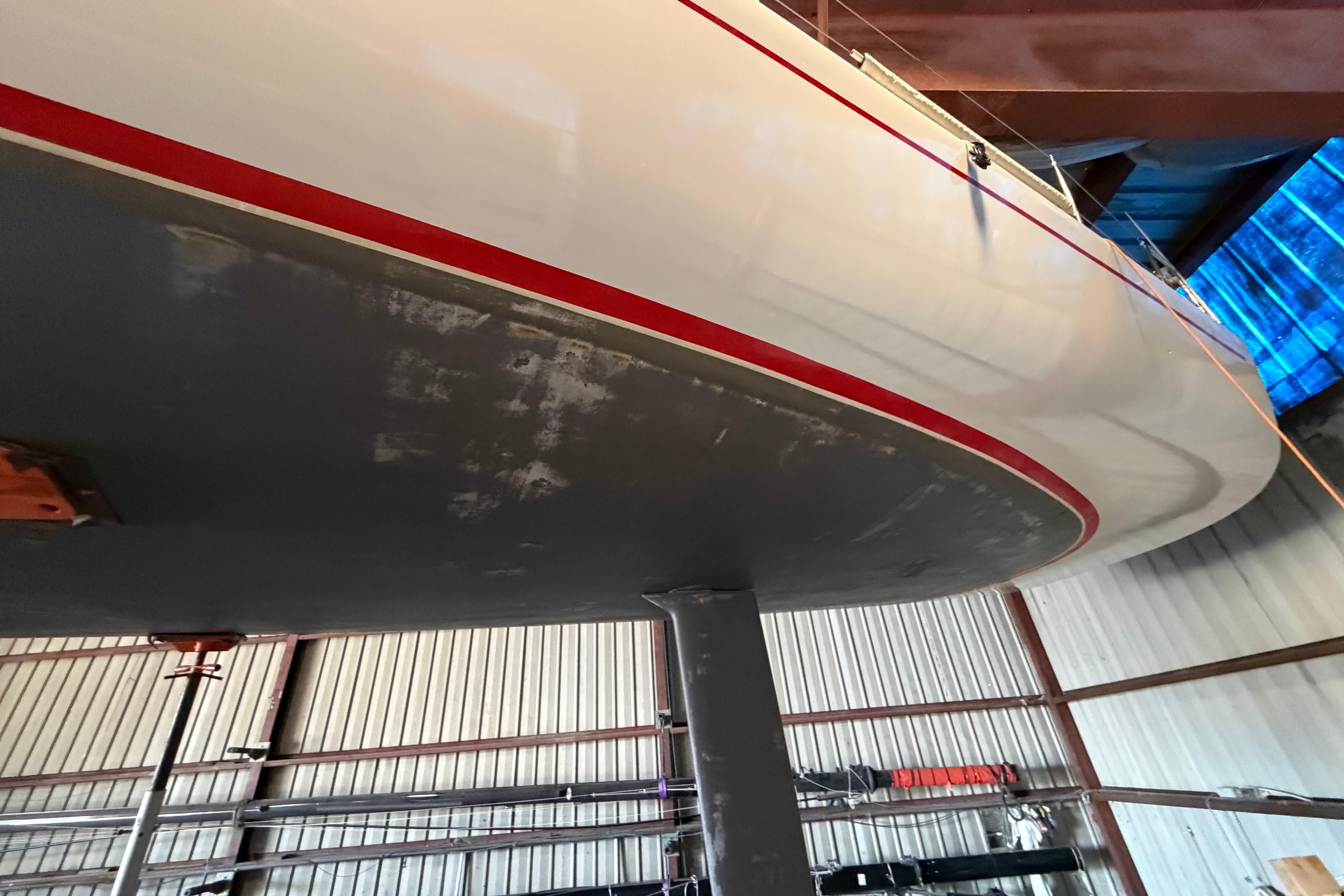 Andrews 63 yacht in a boatyard, showcasing its hull and keel design.