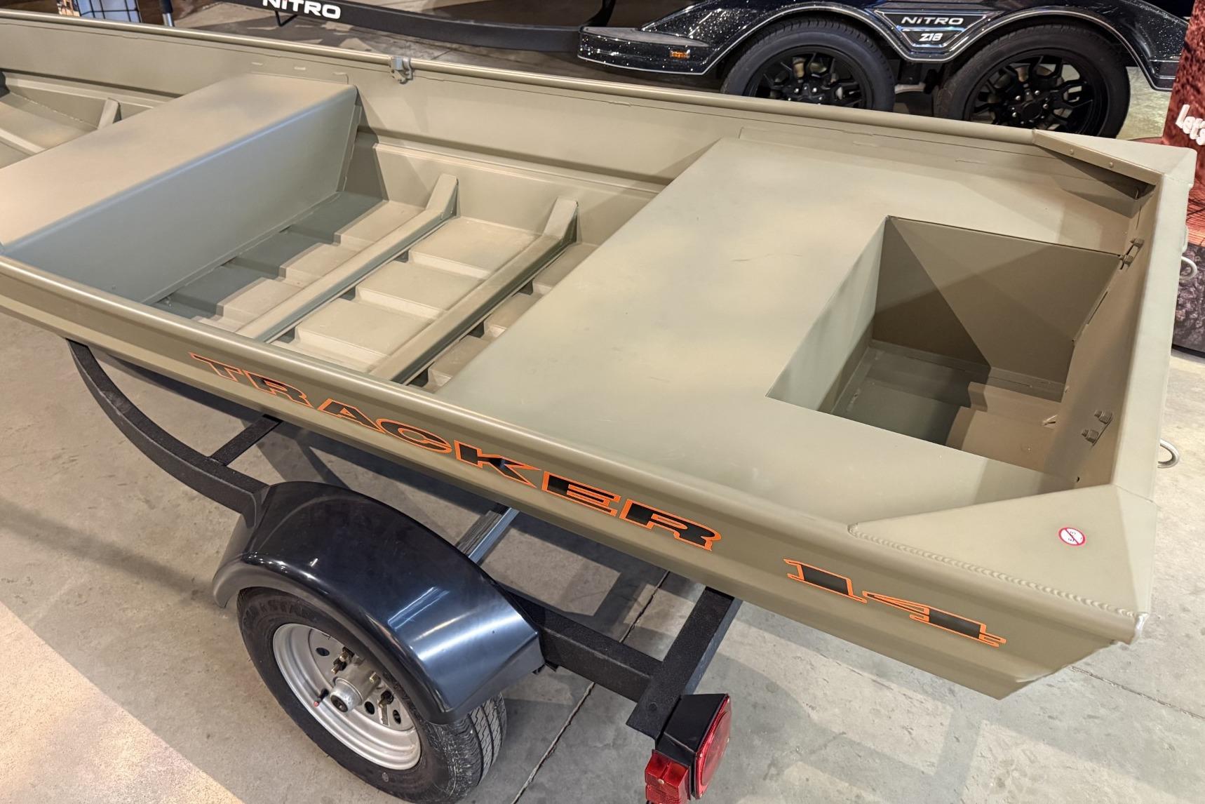 2026 Tracker Grizzly 14 Jon boat on trailer, displayed indoors.