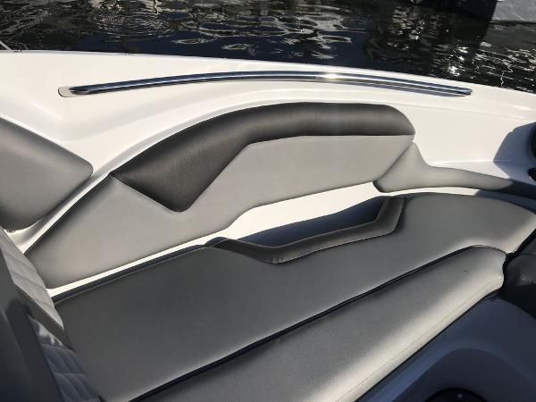 2020 Rinker 29QX BR boat interior with sleek, modern seating and water reflection.