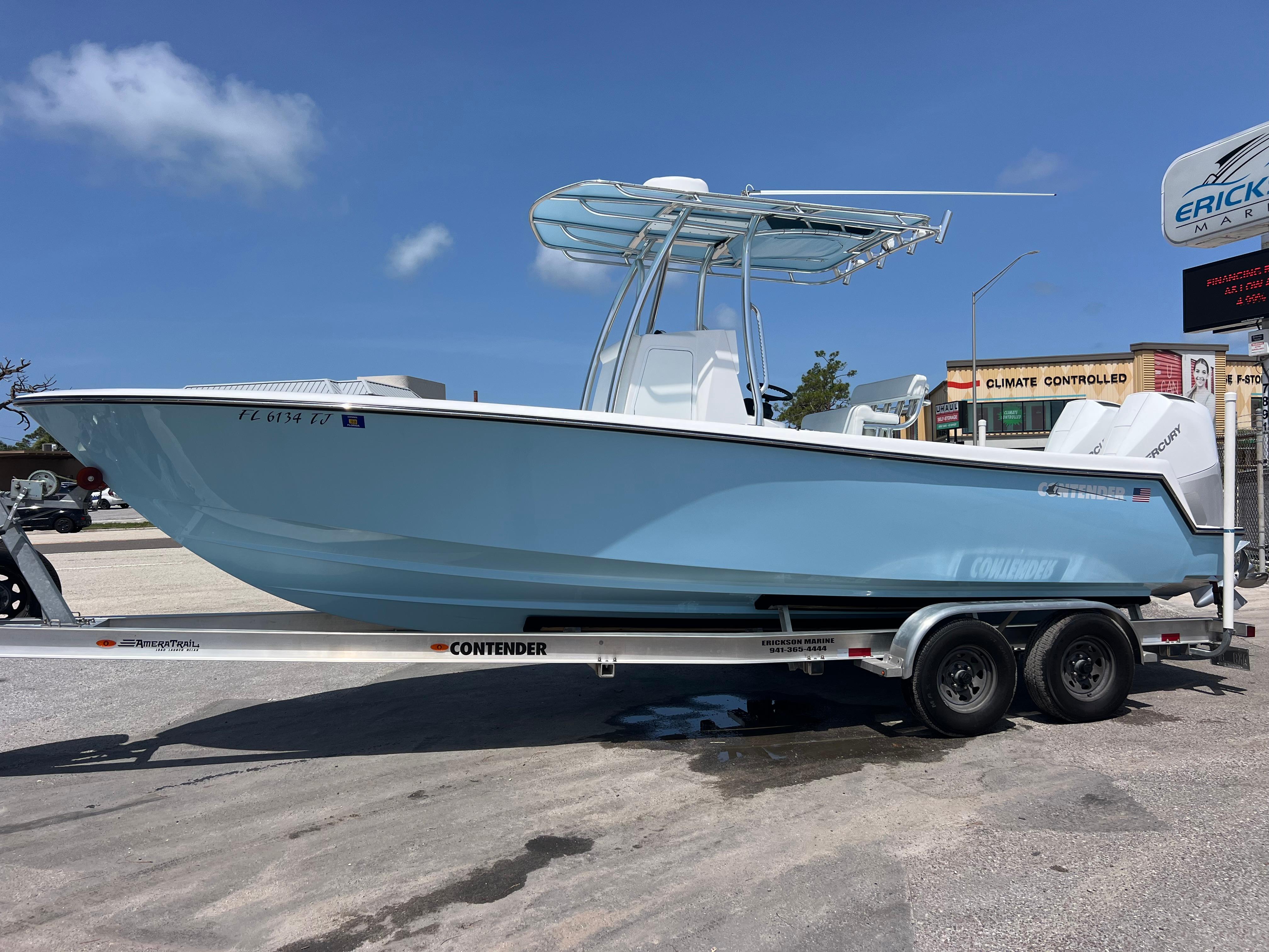 2023 Contender 25 Tournament boat on trailer, light blue hull, sunny day.