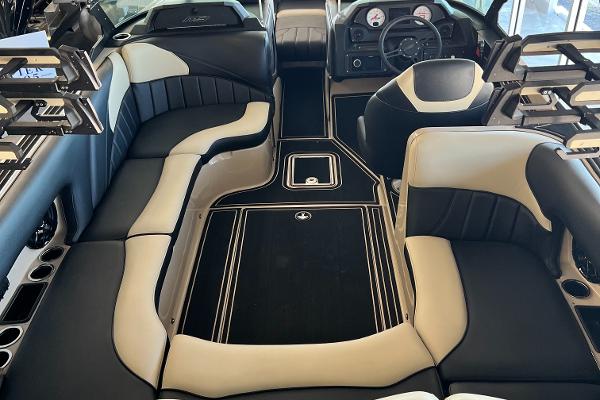 Luxurious interior of 2024 MB F22 Tomcat boat with sleek black and beige seating.