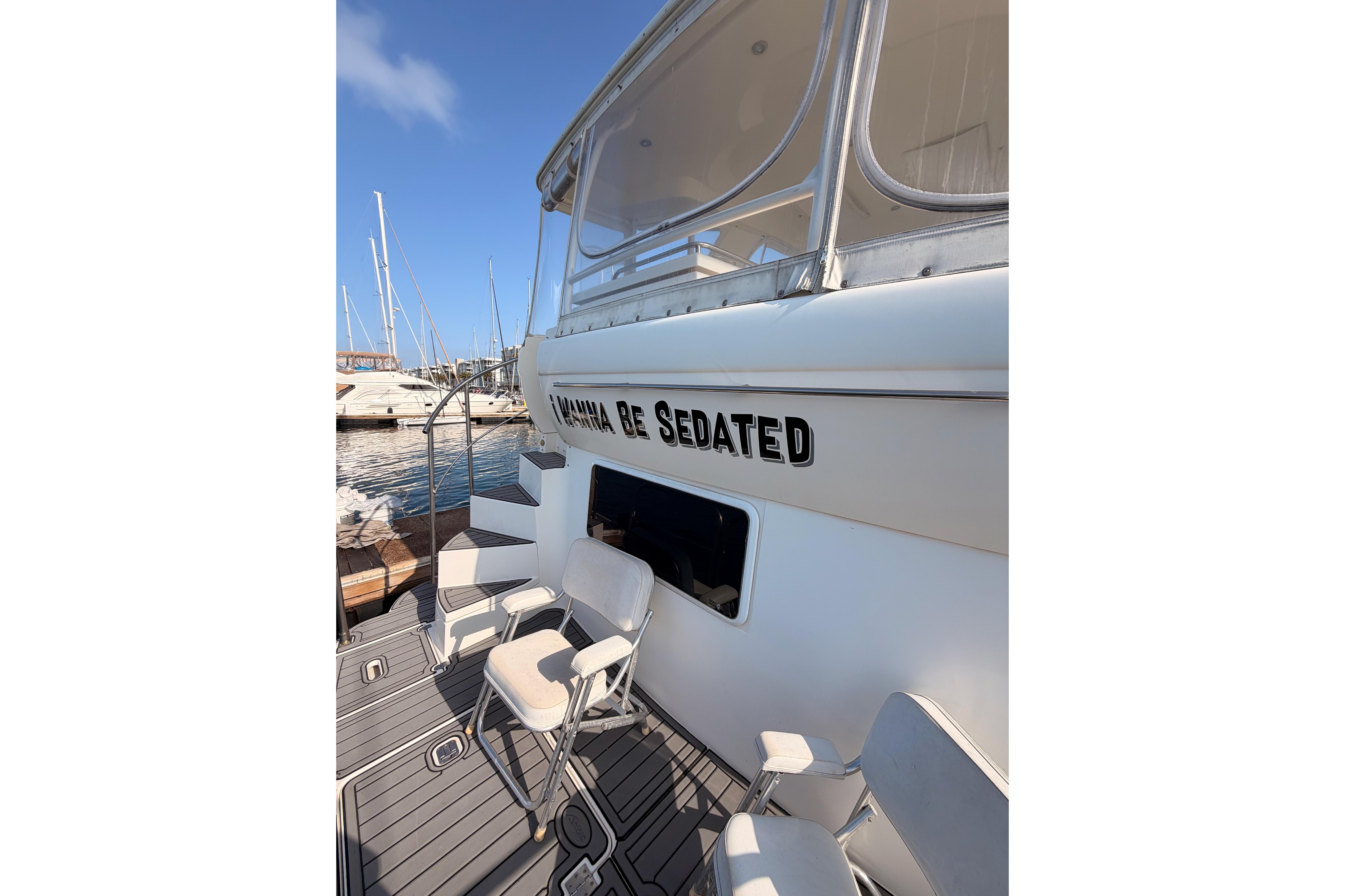 2005 Cruisers Yachts 405 Express Motoryacht docked with seating area.