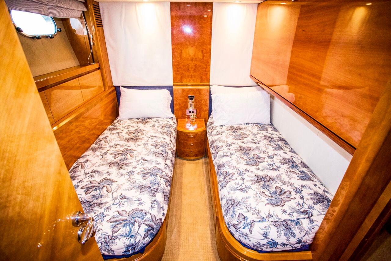 Luxurious twin cabin in 2002 Viking Princess motor yacht with elegant wood finishes.