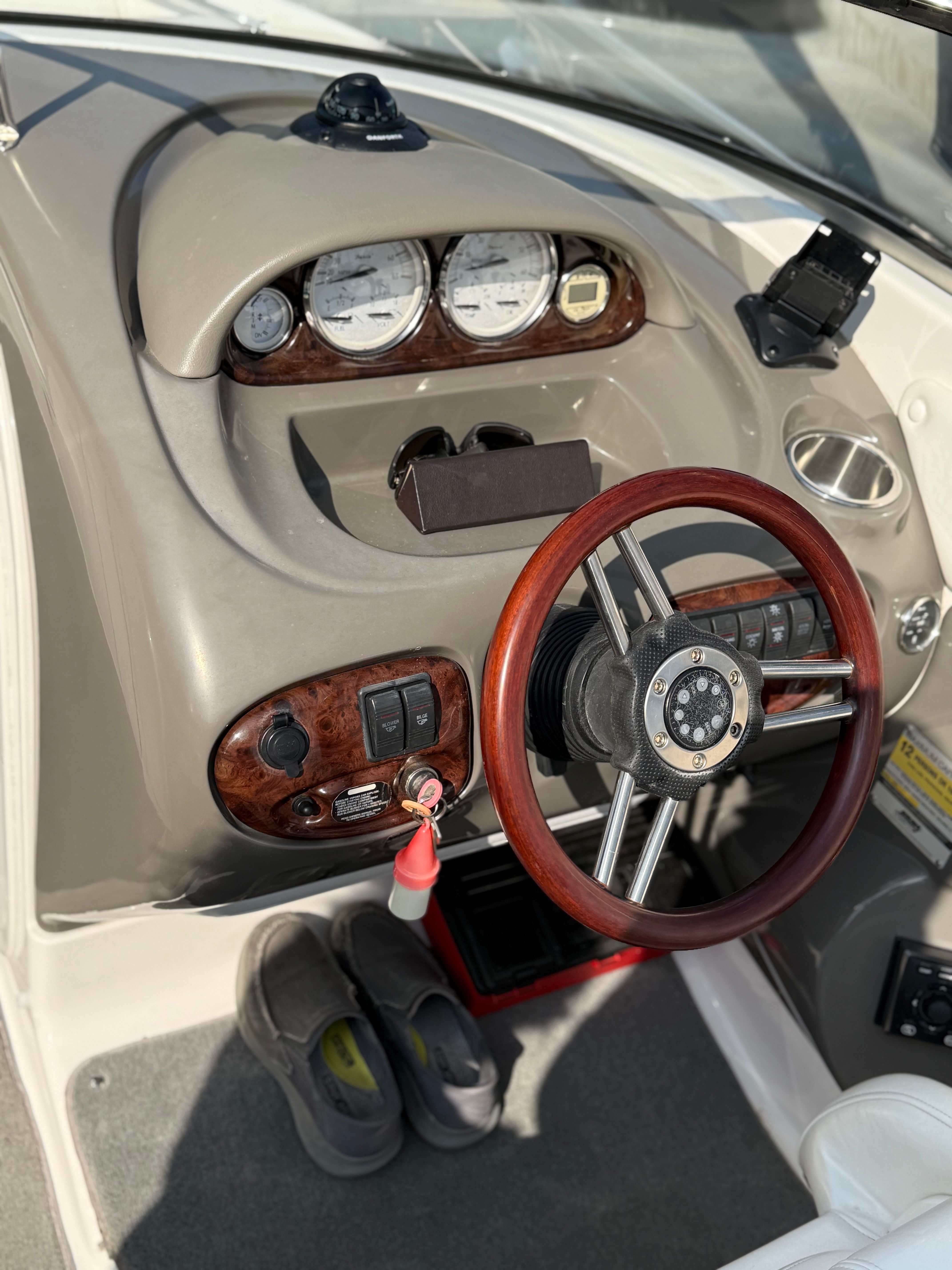 2007 Regal 2400 Bowrider dashboard with wooden steering wheel and gauges.