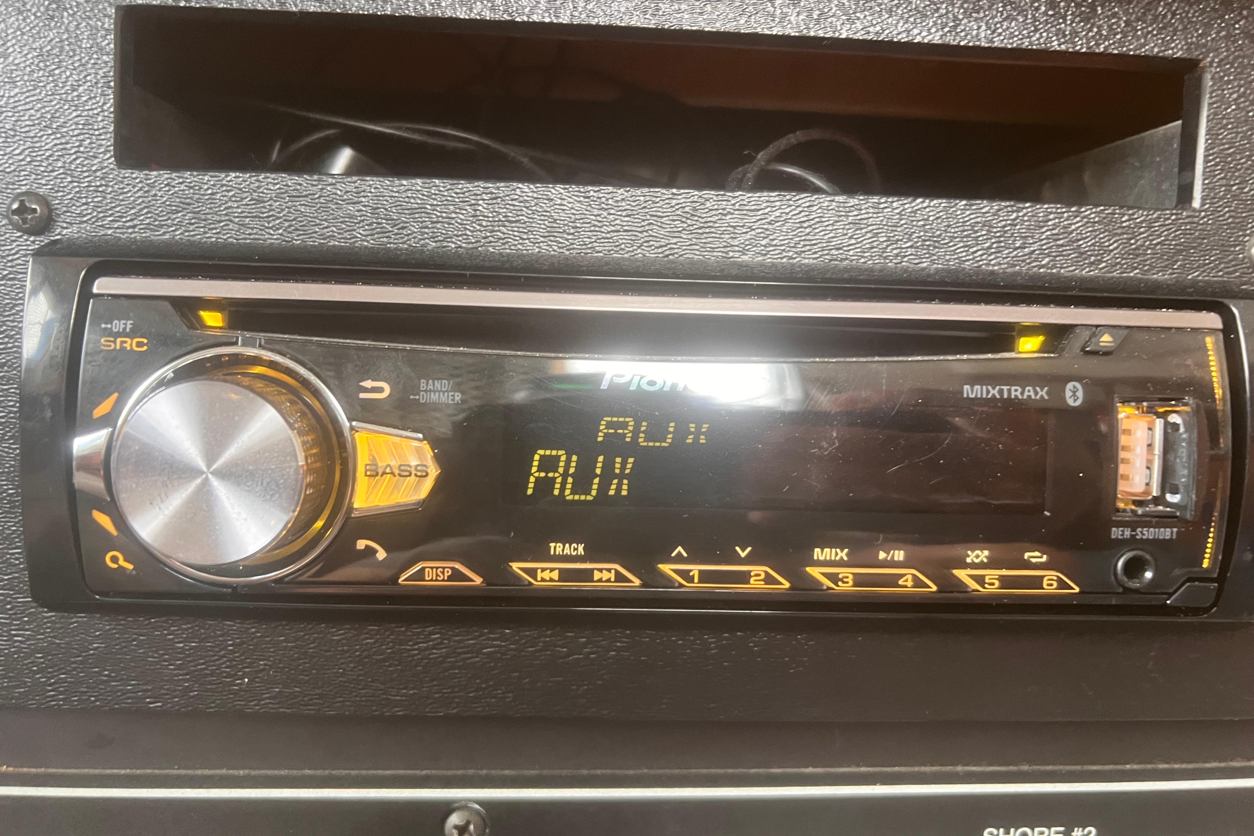 Pioneer car stereo system in a 1994 Carver 350, displaying "AUX" mode.