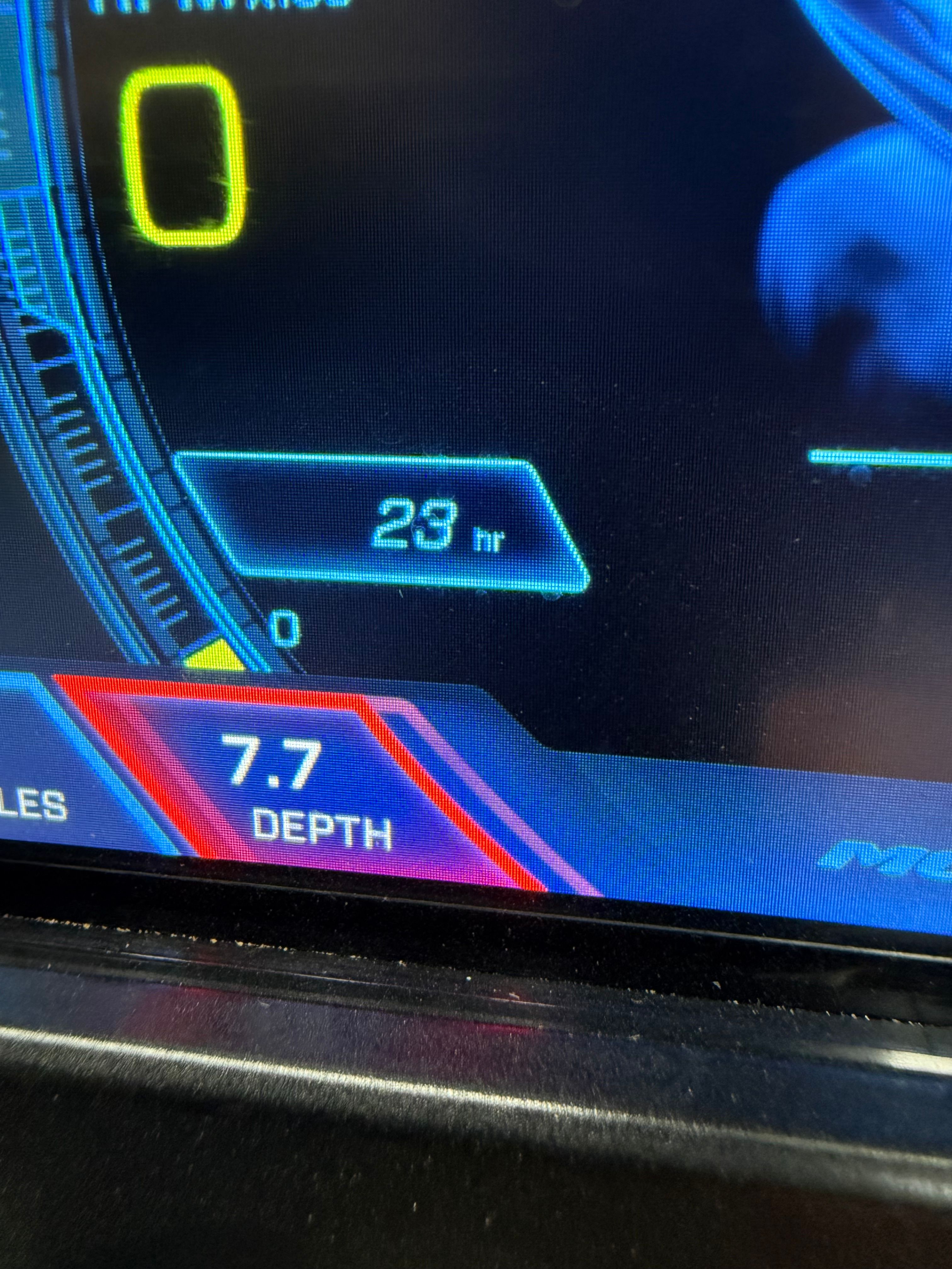 Digital display shows 23 operating hours and 7.7 depth.